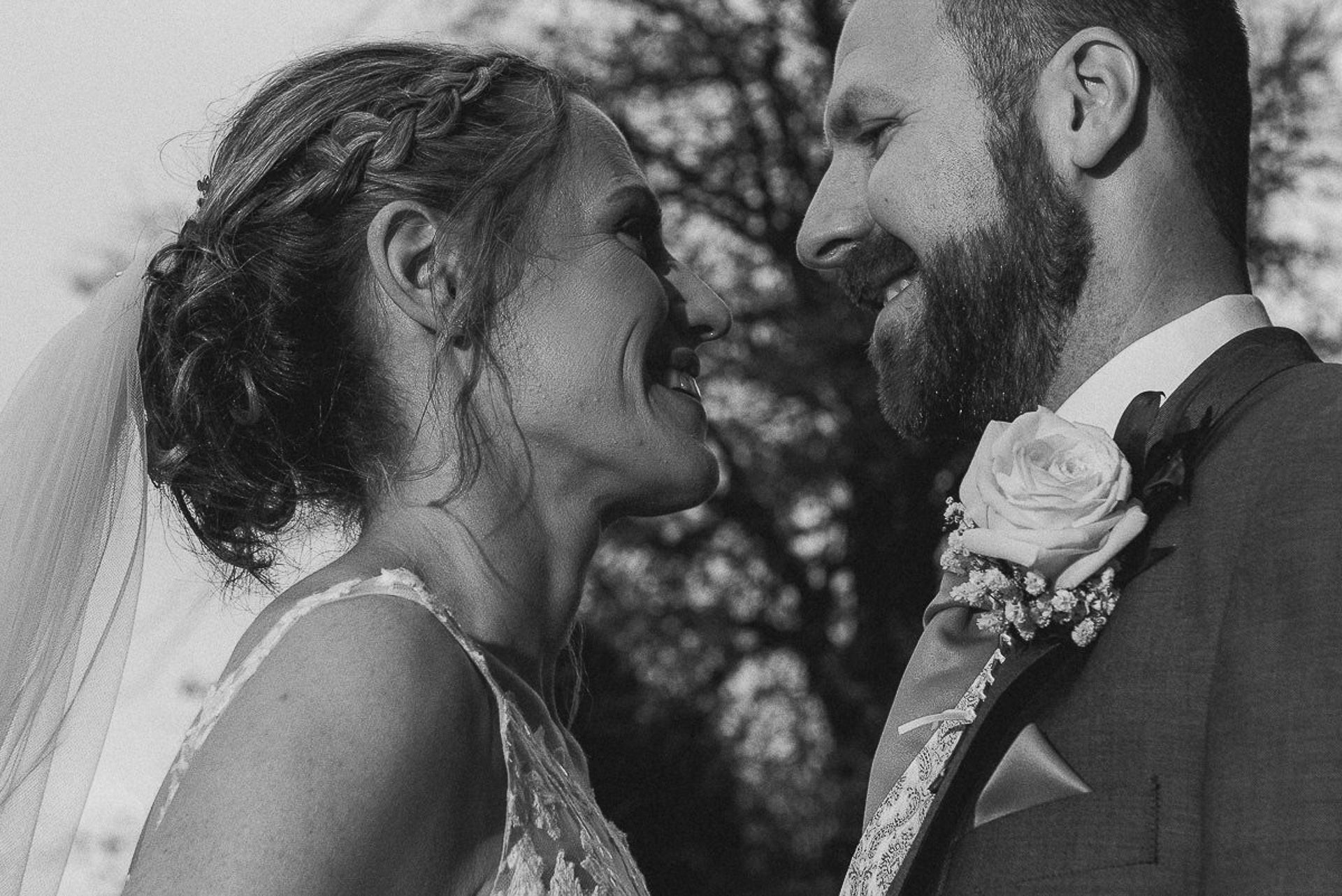 black and white close up photo of bride and groom looking into each others eyes