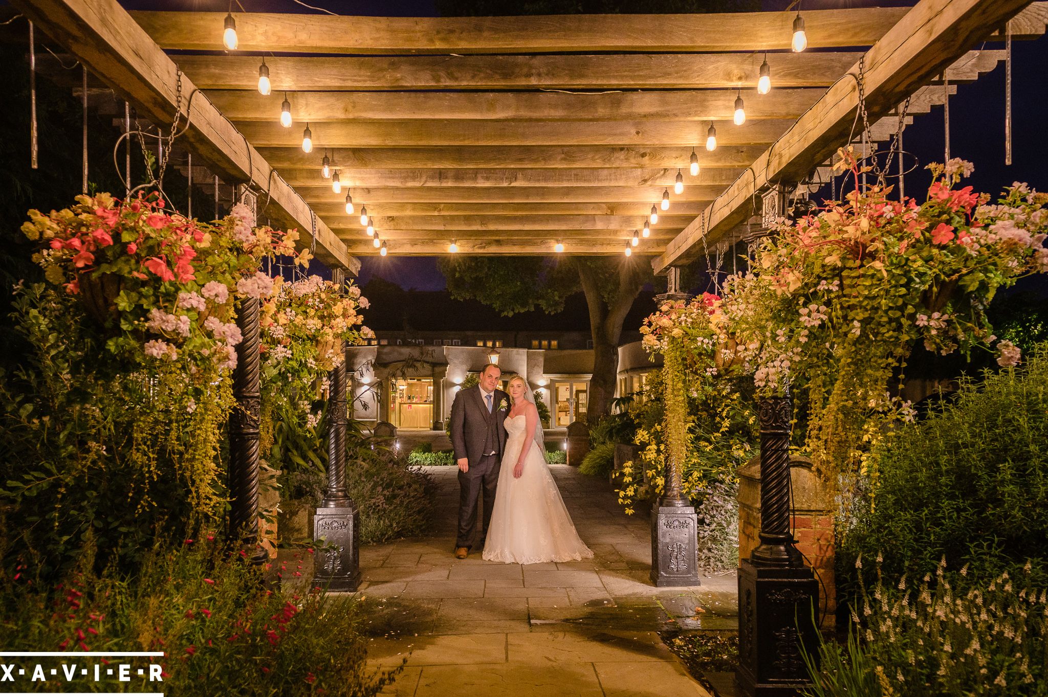 bride and groom stand under the pagoda