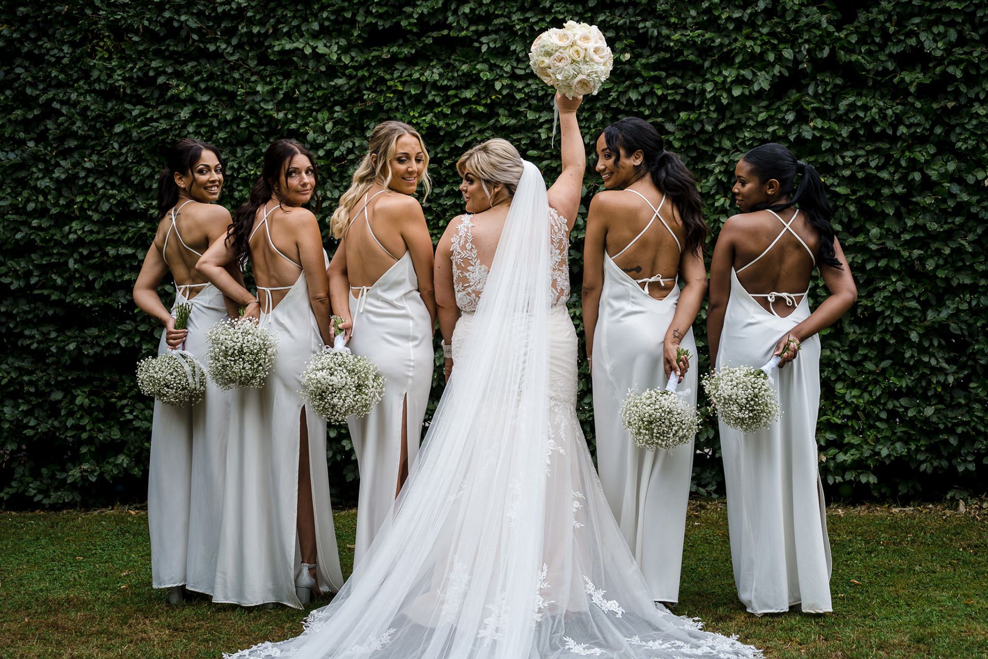 bride poses with bridesmaids