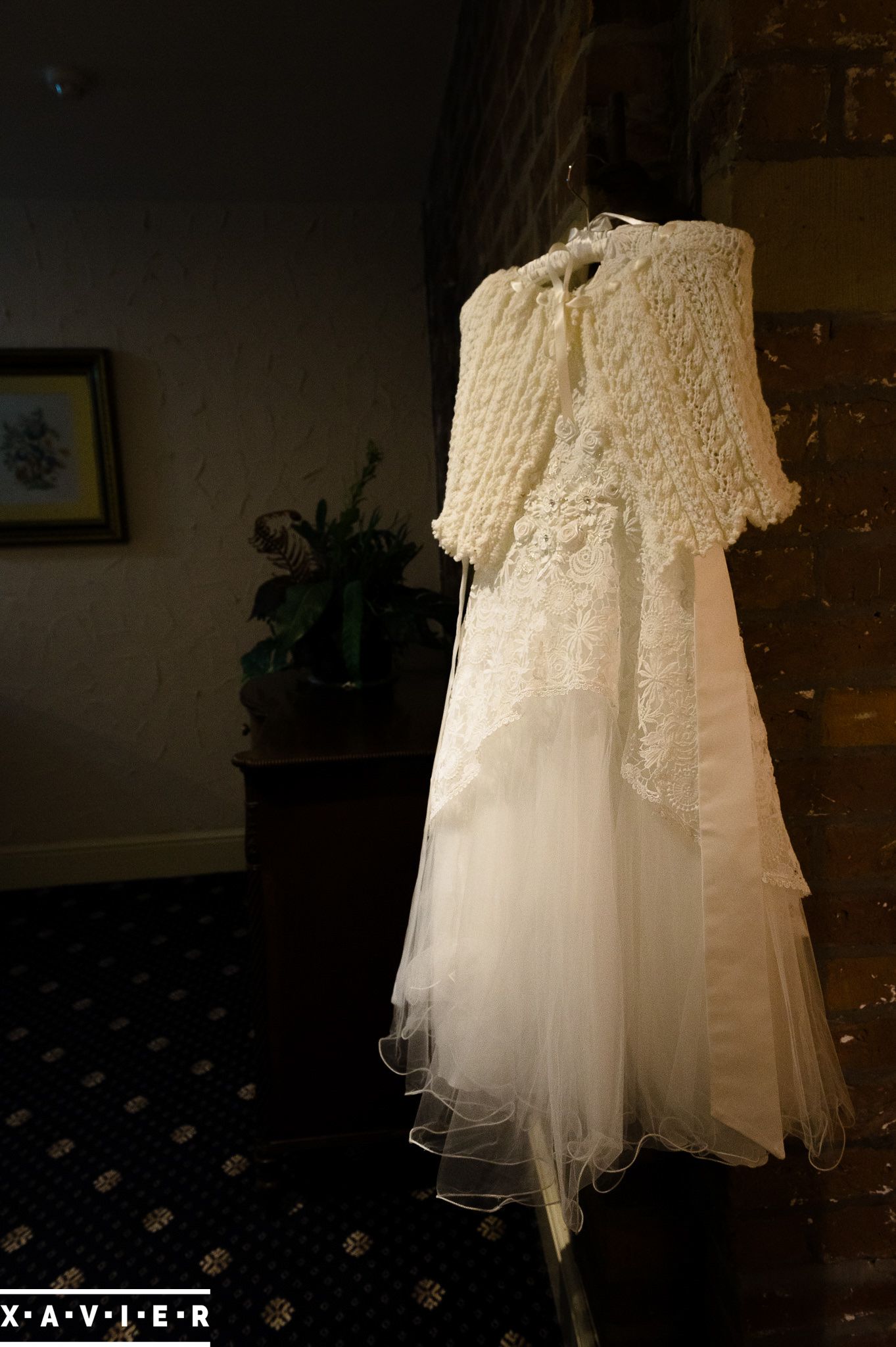 flower girls dress hangs by the stairs