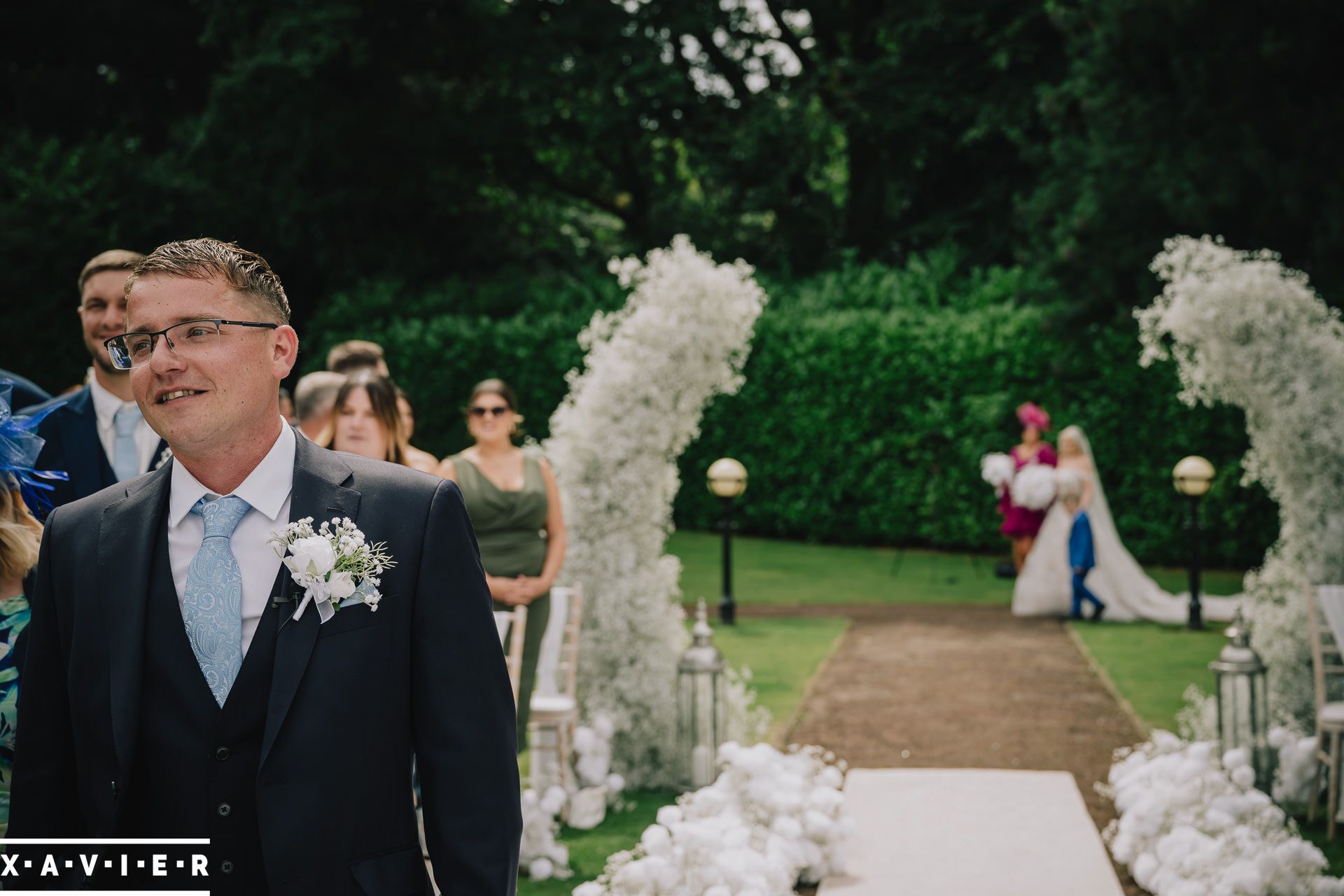 close up of groom at at the altar with bride in the background 