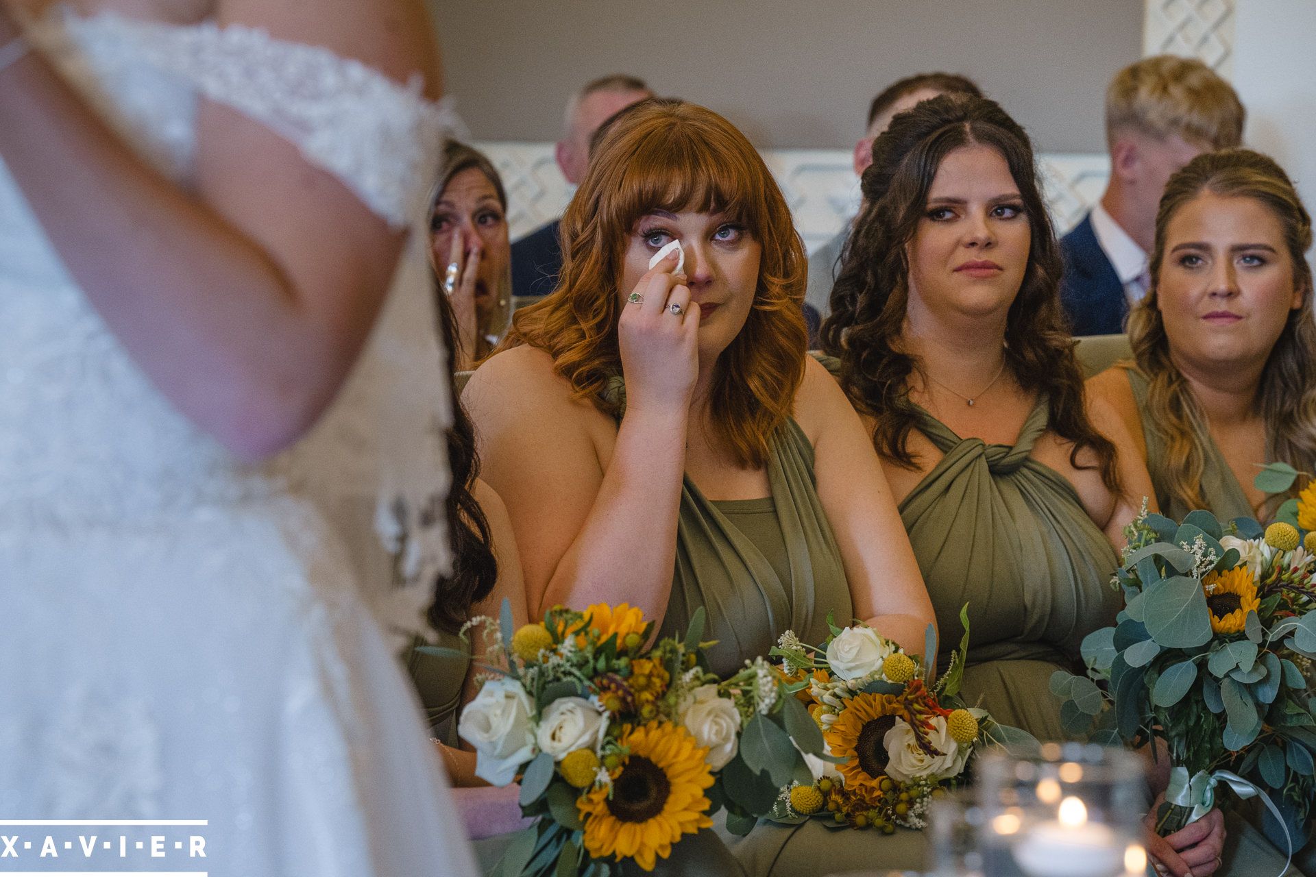 bridemaid wipes away a tear during the ceremony