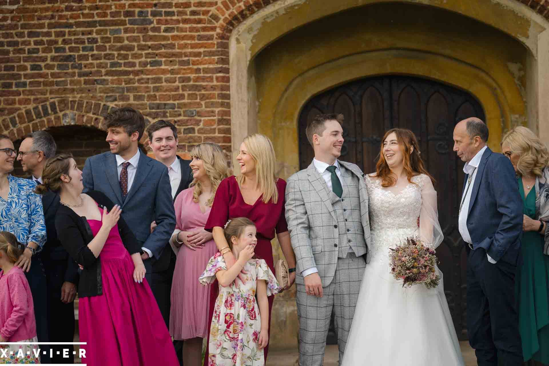 Guests giggle and laugh with each other during the group photo