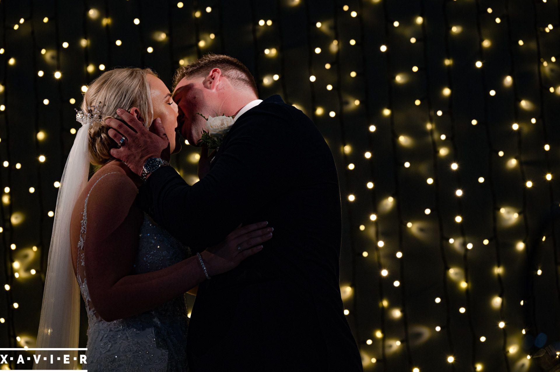 bride and groom having their first kiss