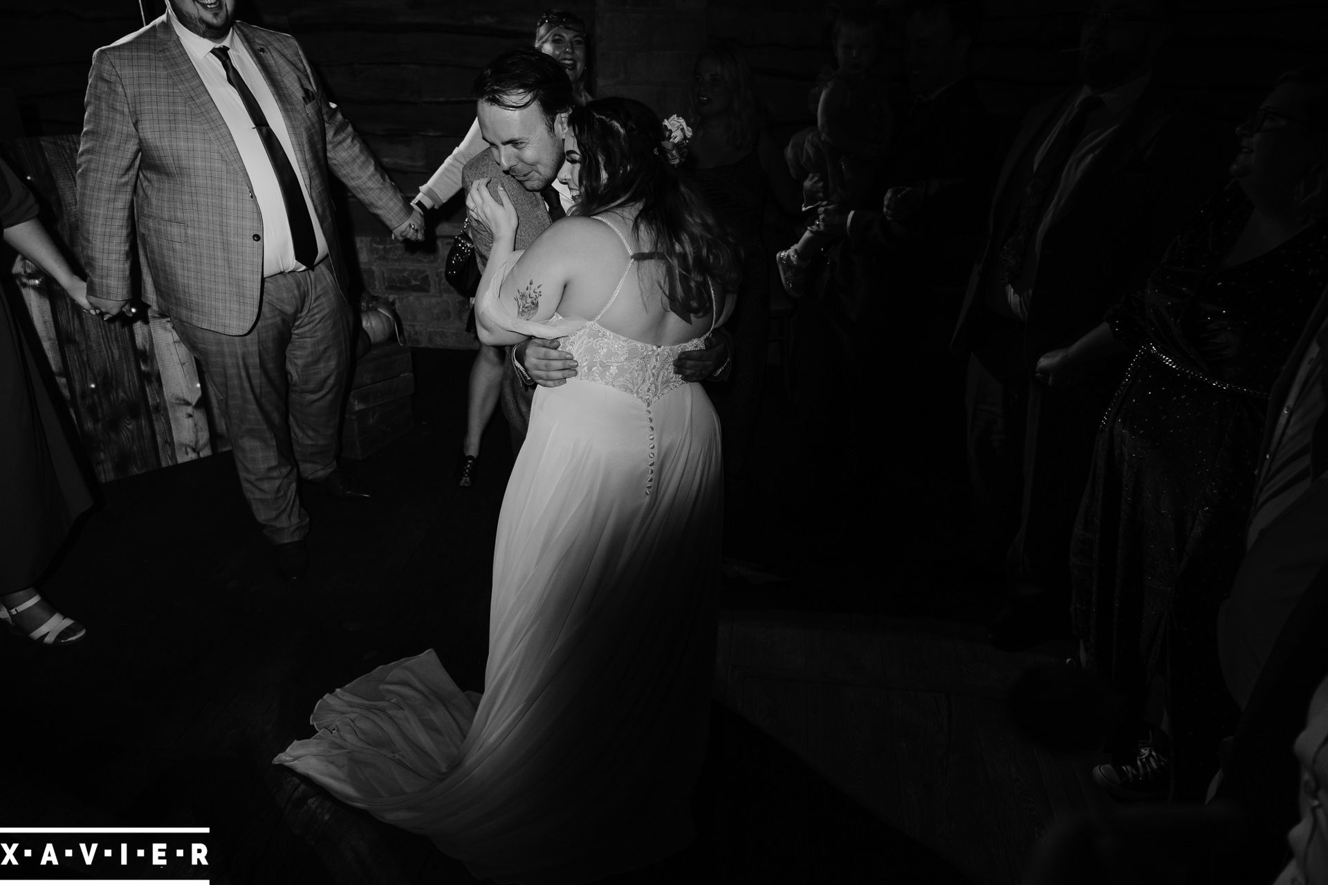 Guests form a ring around the bride and groom