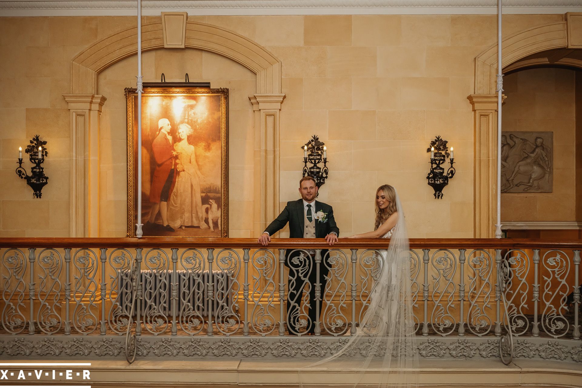 bride and groom standing on the balcony at Oulton Hall