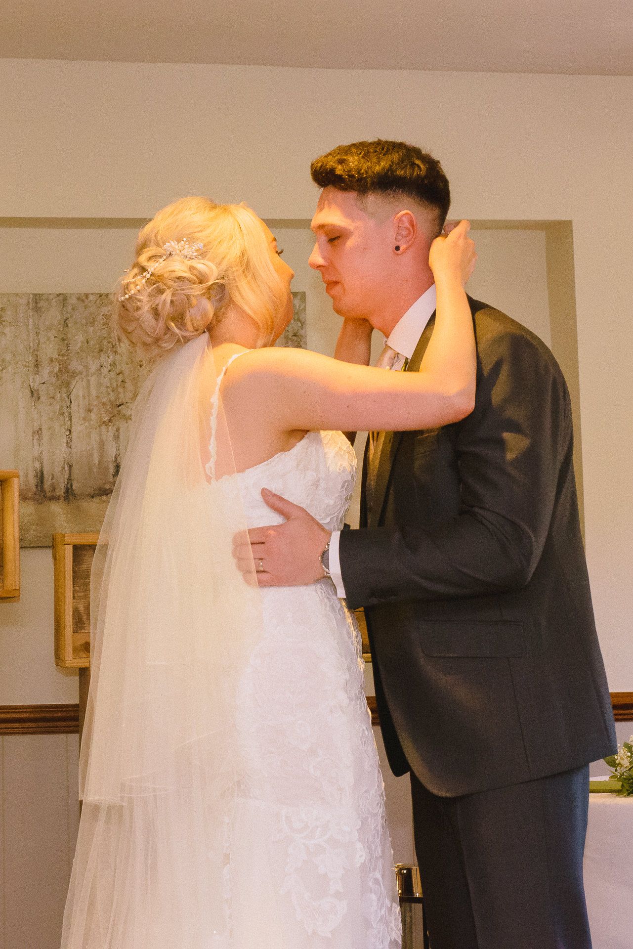bride and groom are about to kiss for the first time