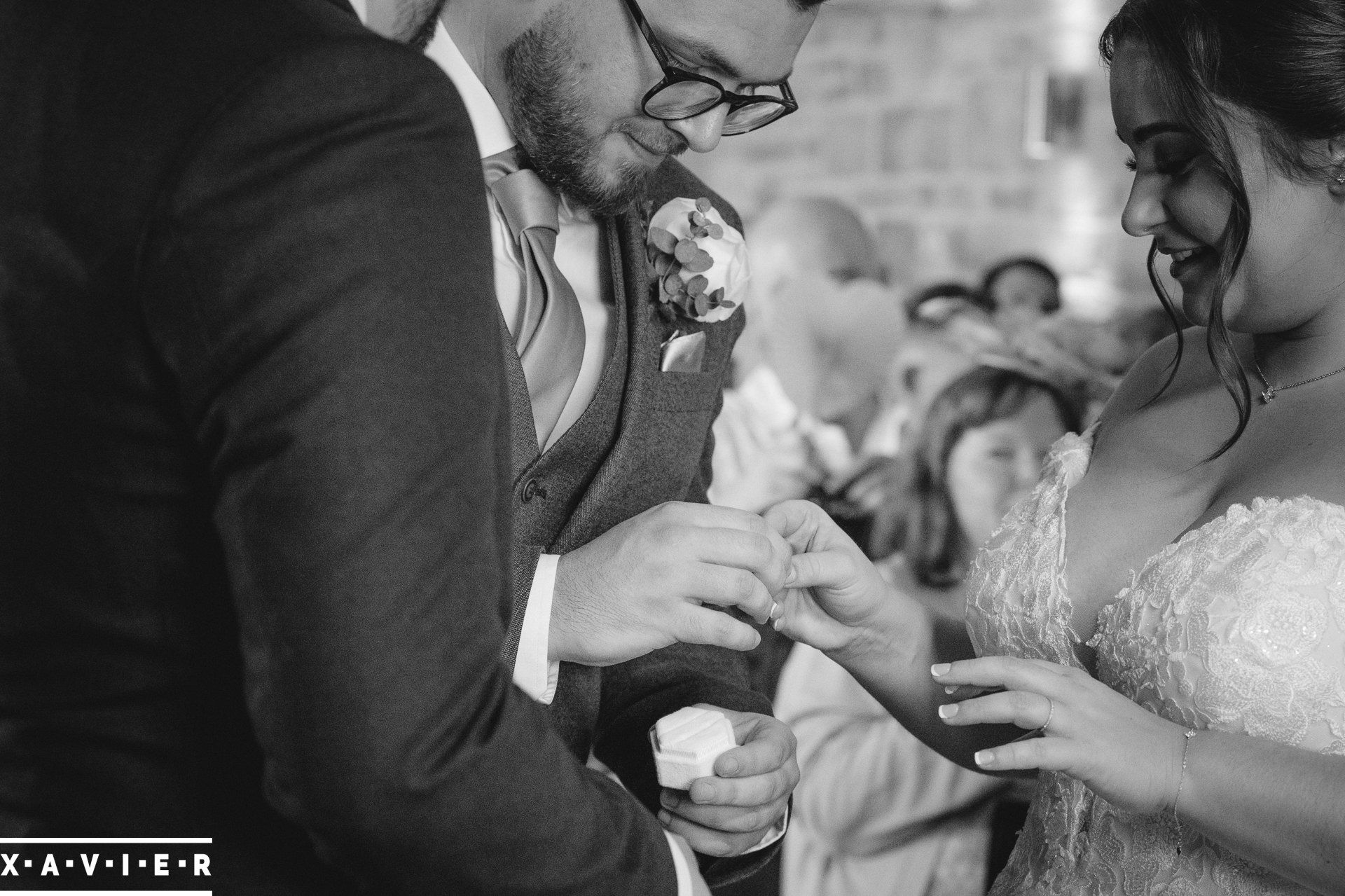 The bride accepts the ring from the best man