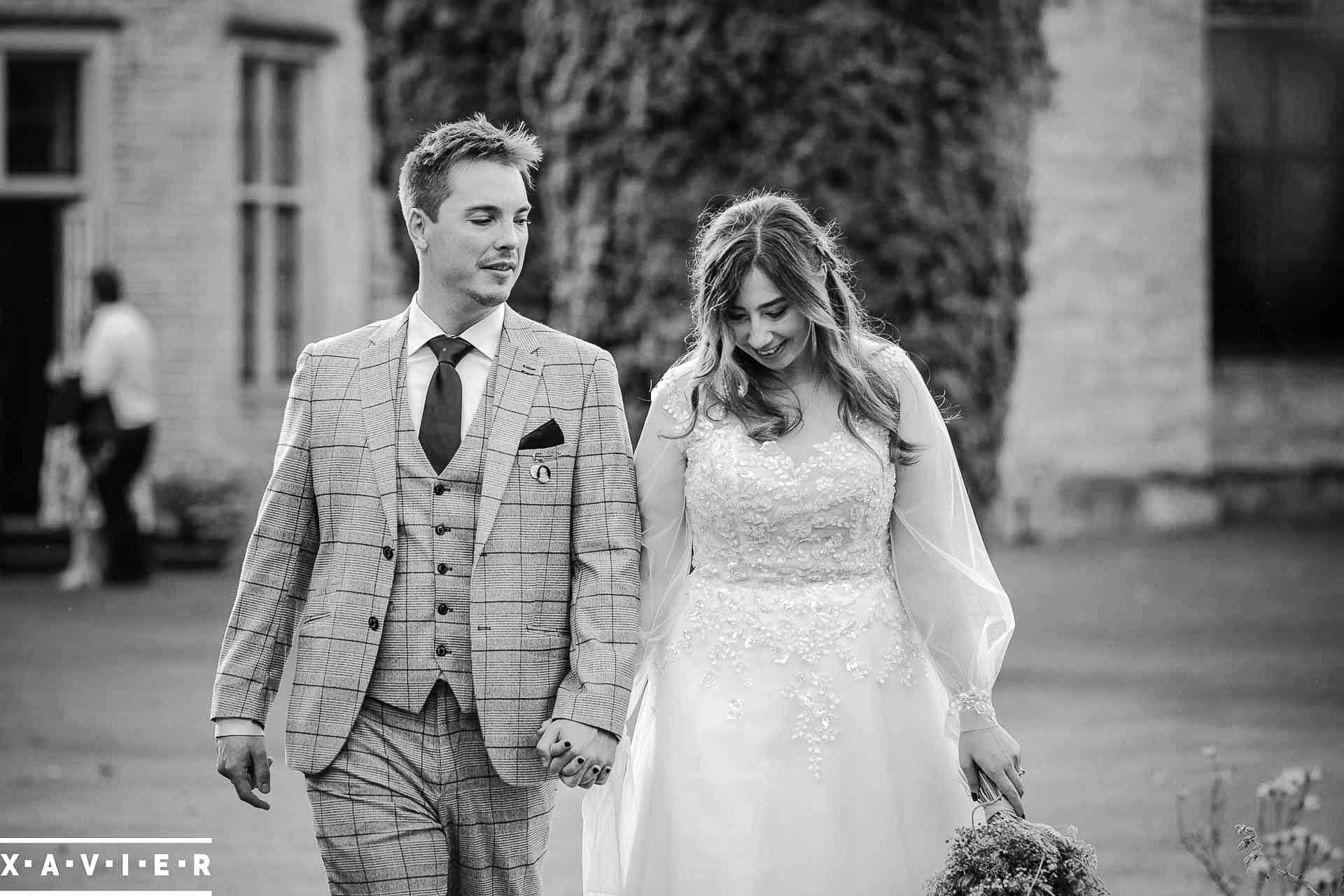 Bride and groom walk in Home Pierrepont Hall