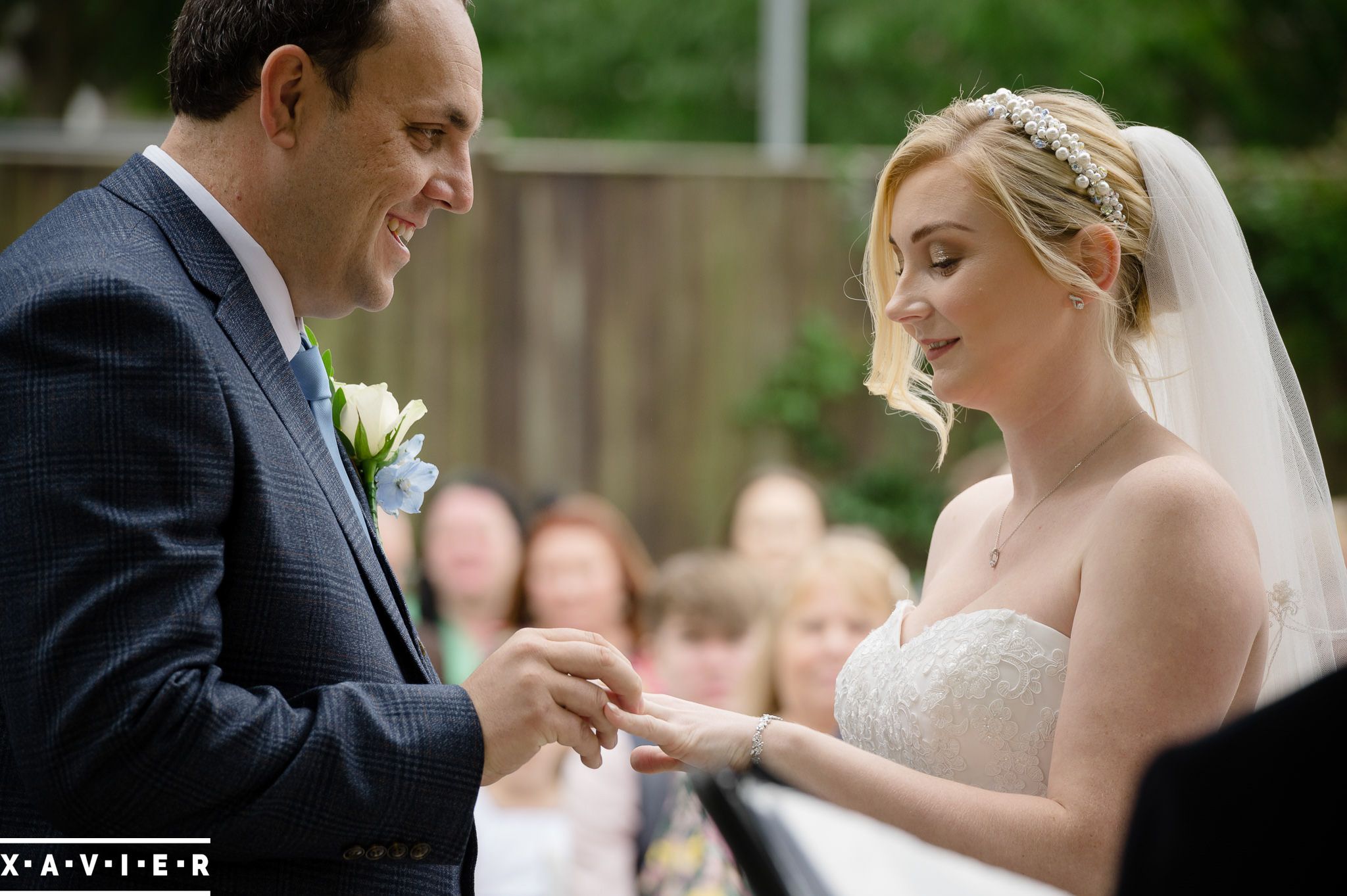 groom puts the ring on the brides finger