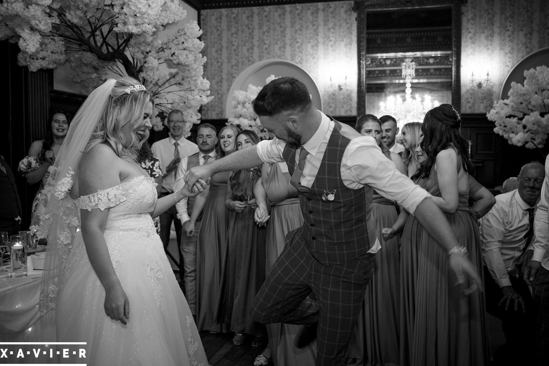 Groom snaps is heels to the bride