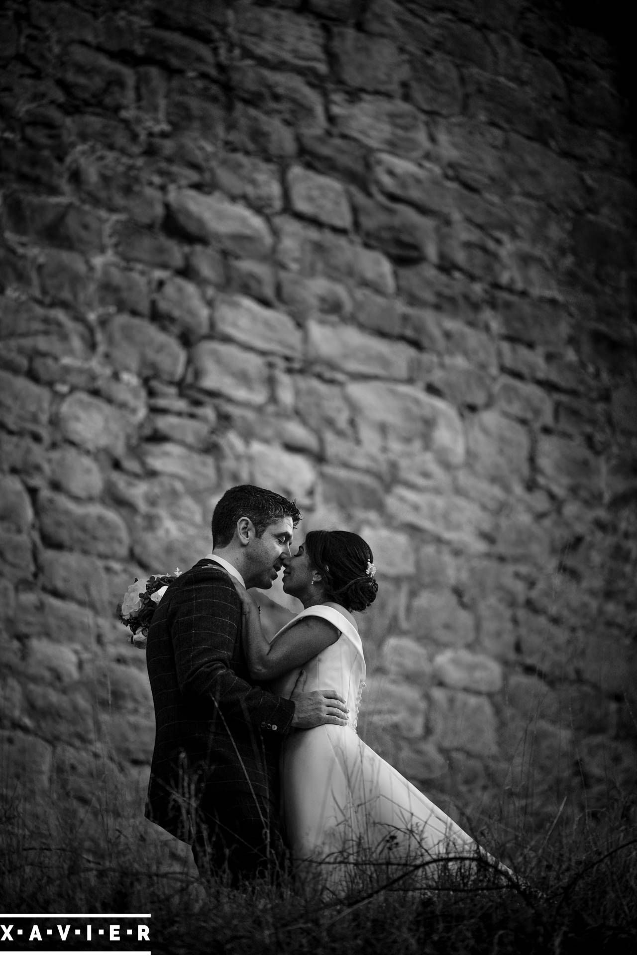 Bride and groom stand by Barden Tower