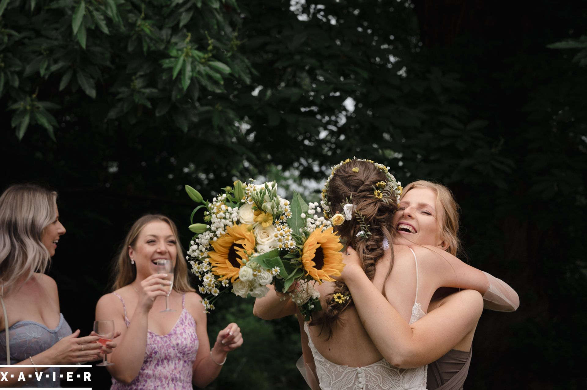 bride higs the bridesmaid after she catches the bouquet