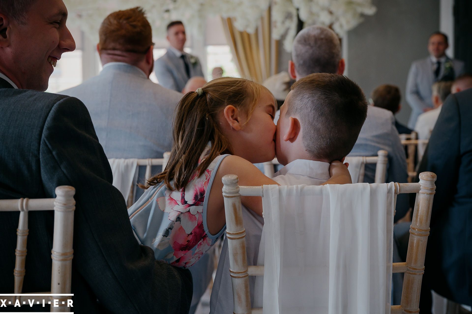 two young guests kiss