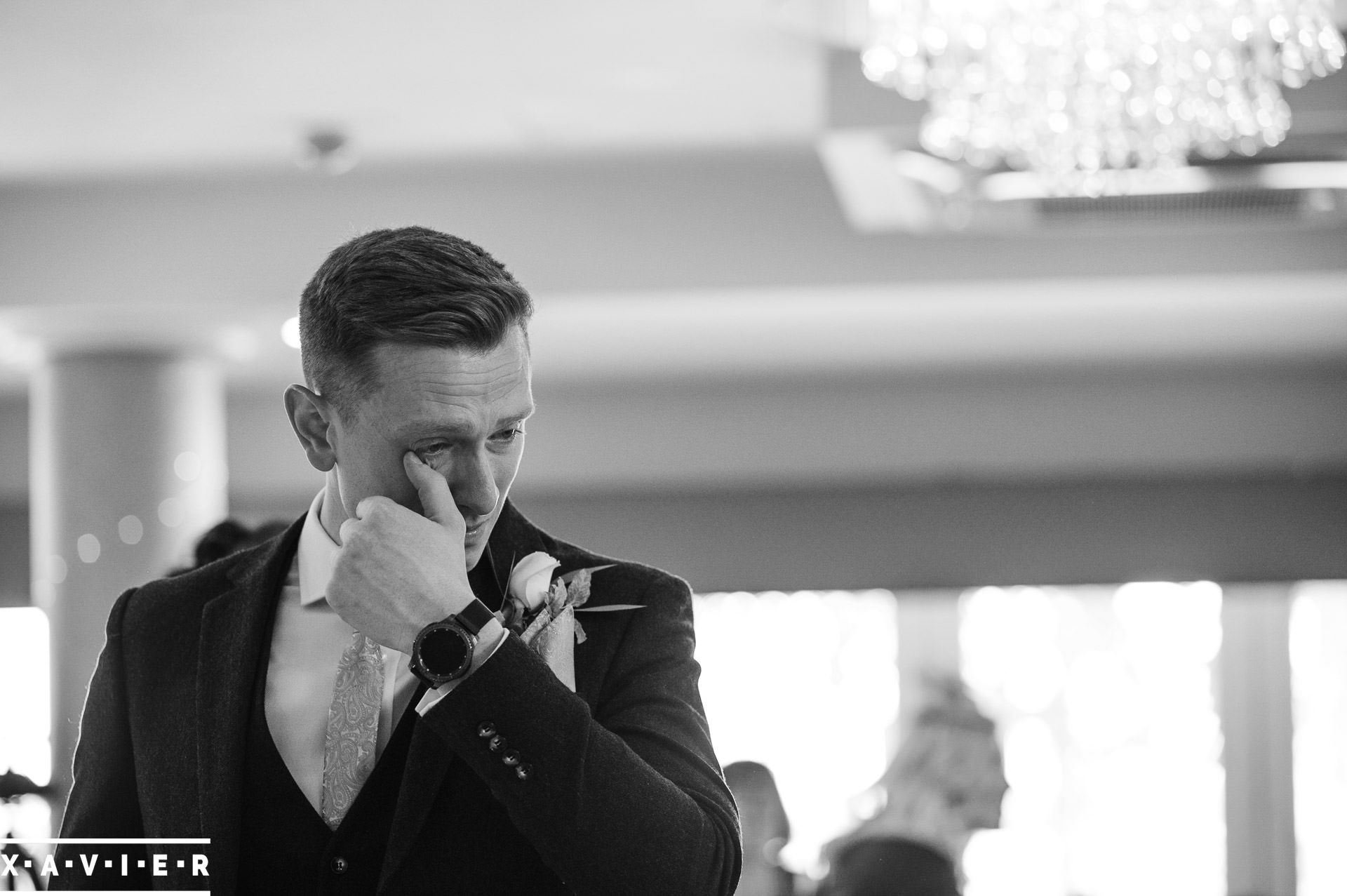 best man wipes away a tear