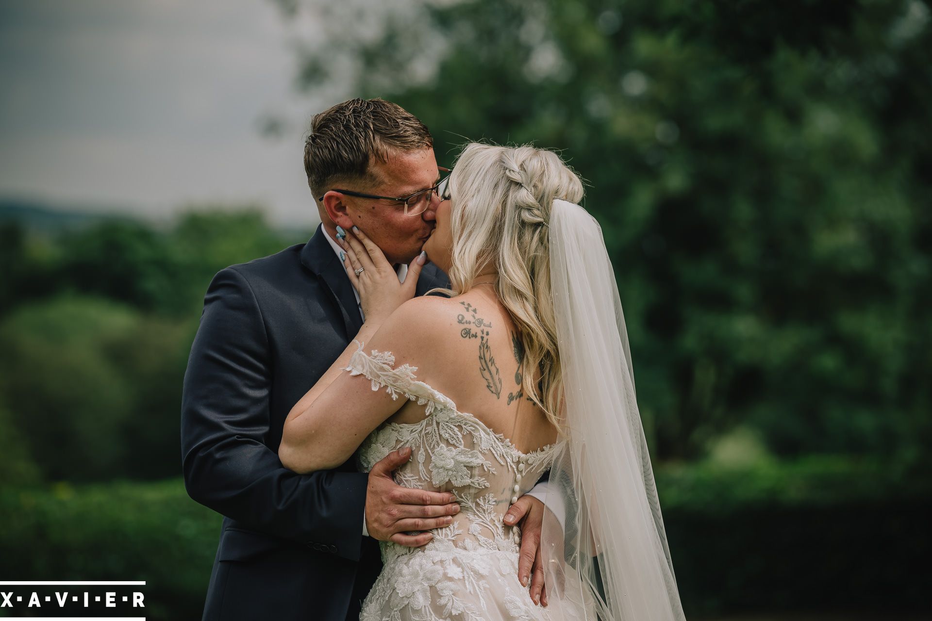 bride and groom kissing in the grounds of Oulton Hall