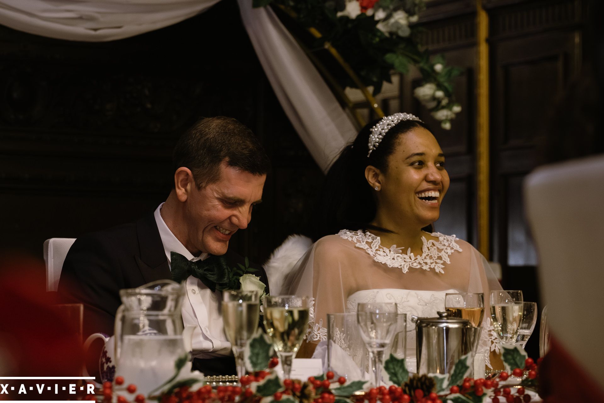 Bride and groom laughing during the wedding speeches