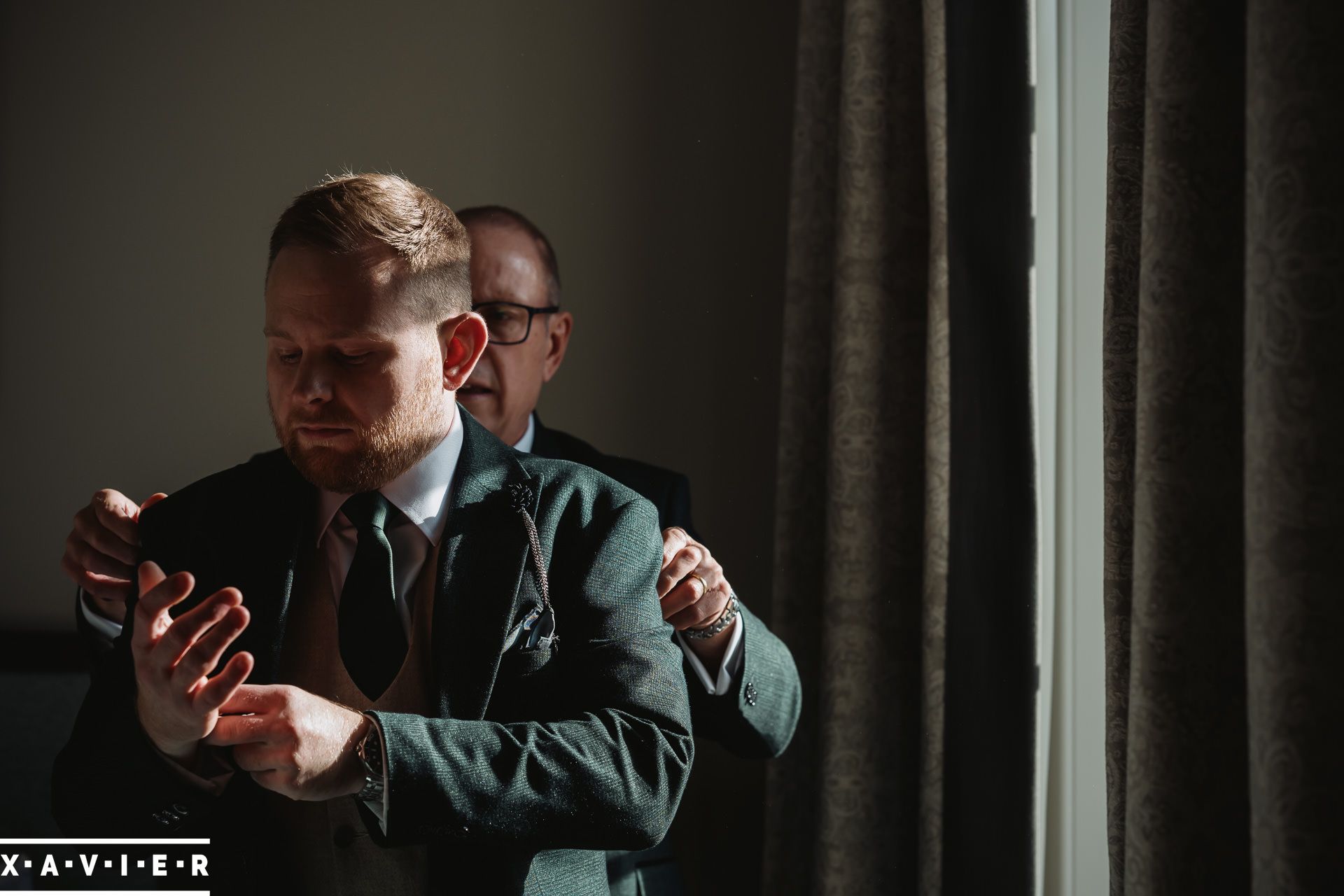 father helps the groom get ready