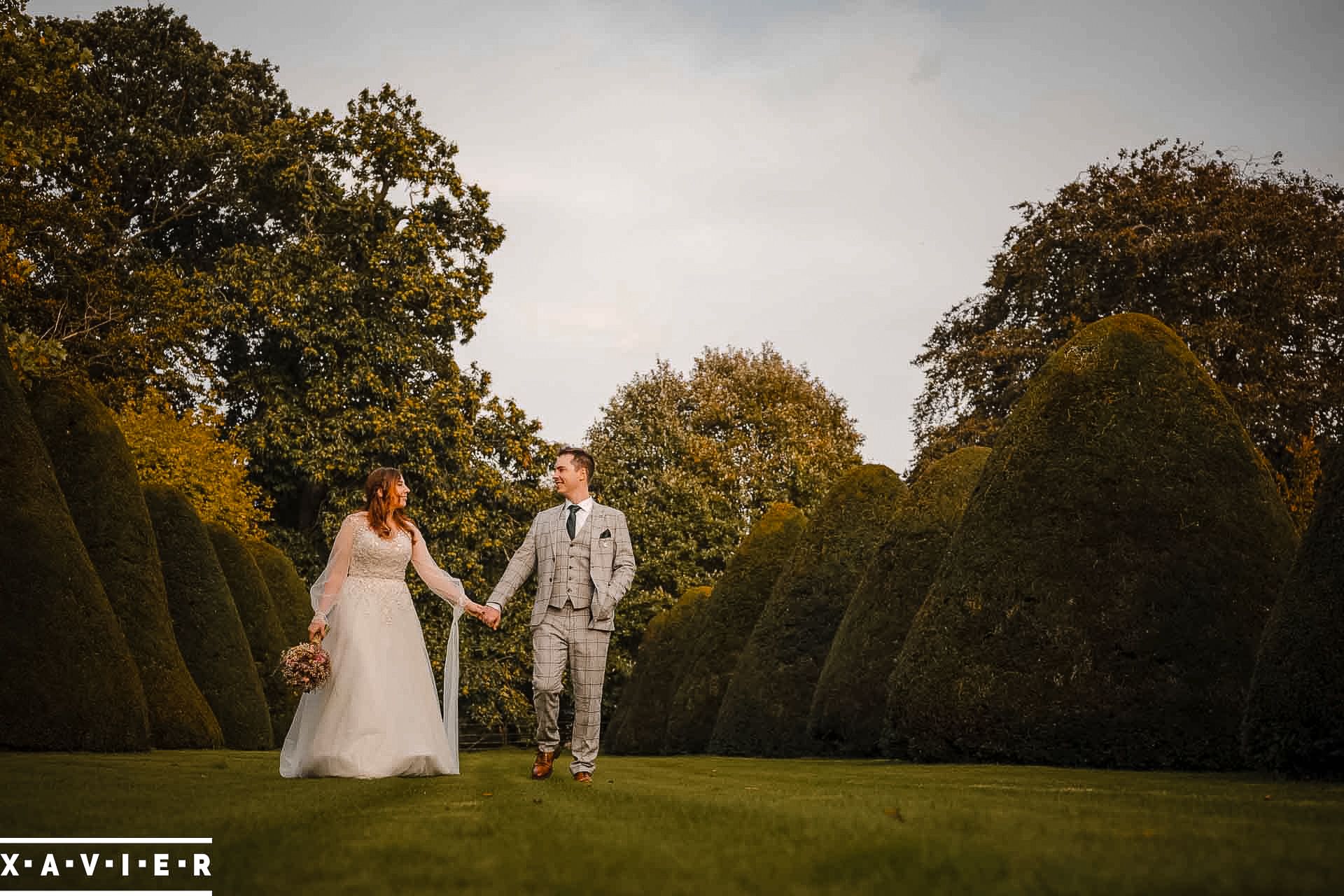 bride ands groom walk hand in hand