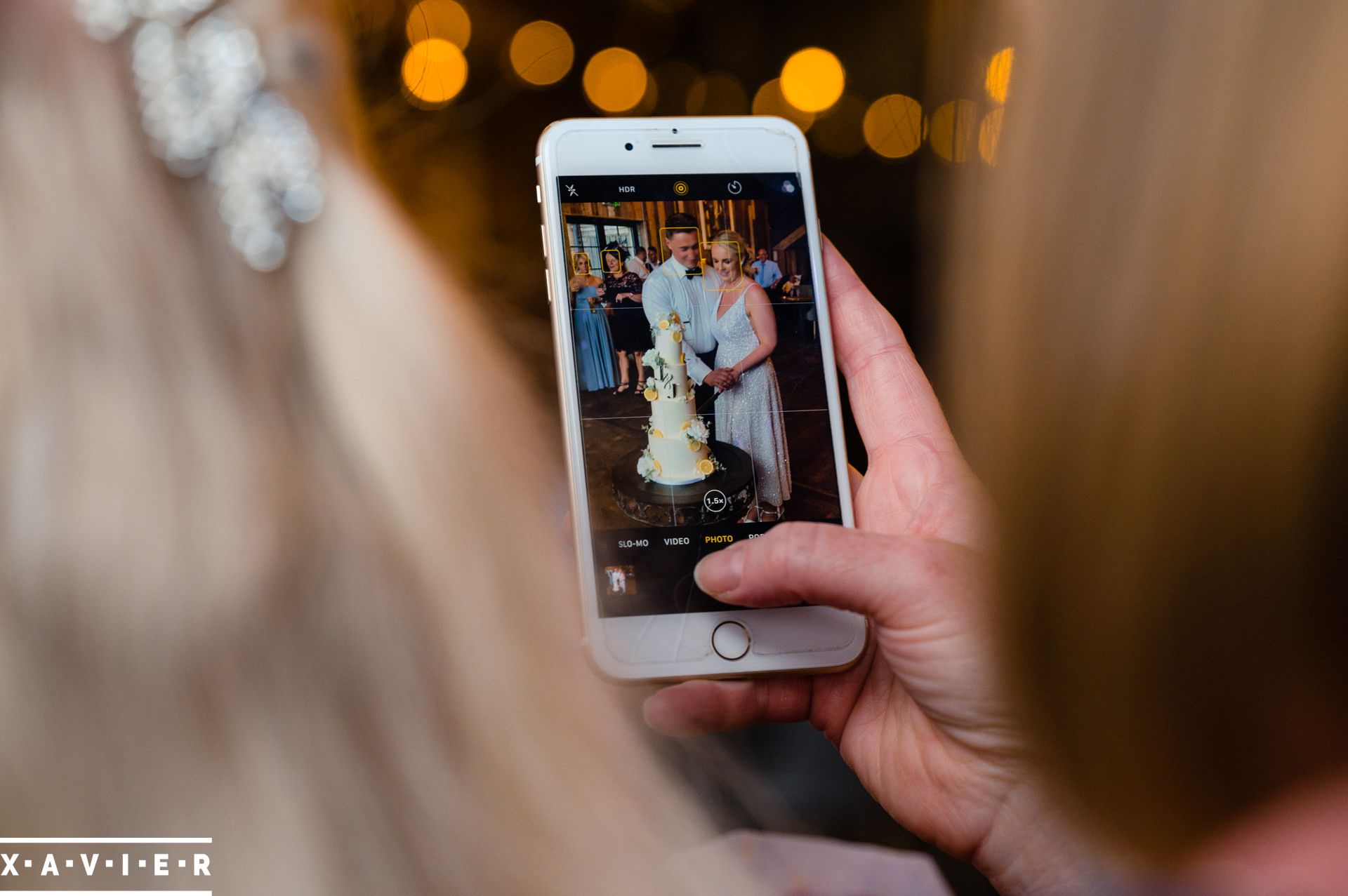 phone shows bride and groom cutting cake