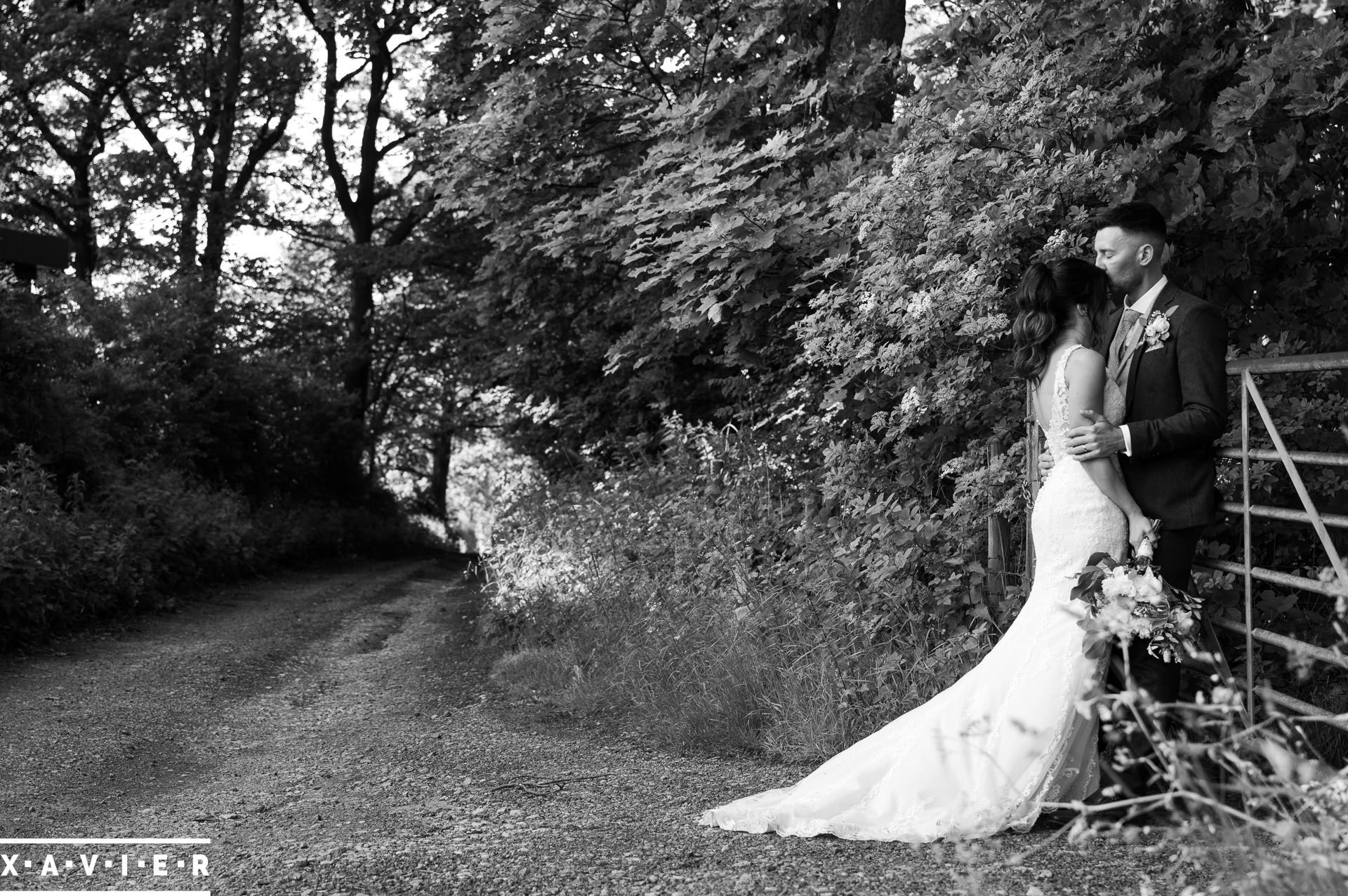 Bride and groom kissing by the gate