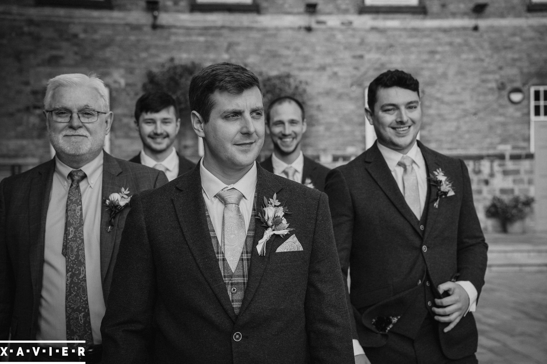 the groomsmen walk to the venue