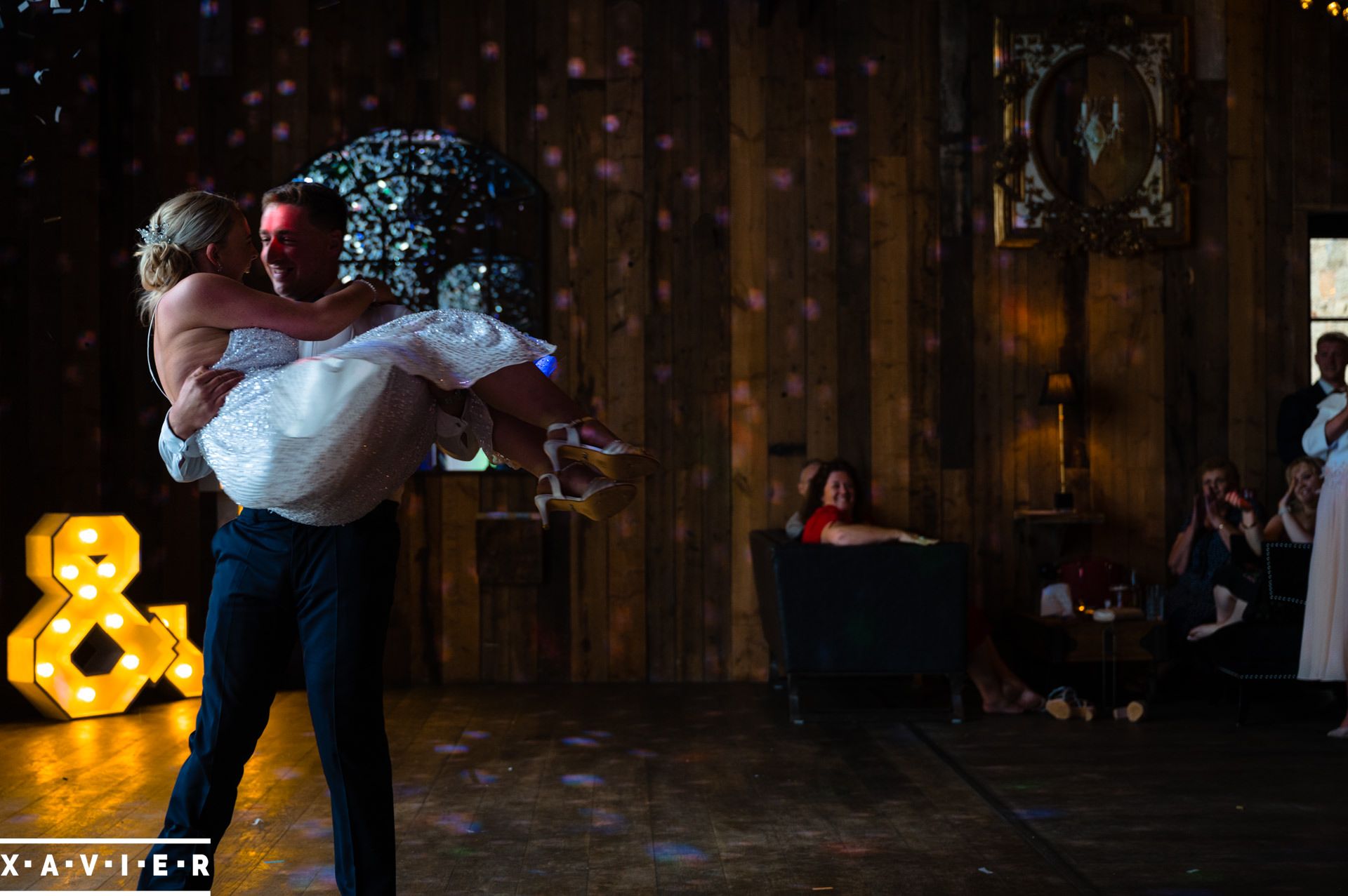 the carries his bride for their frst dance