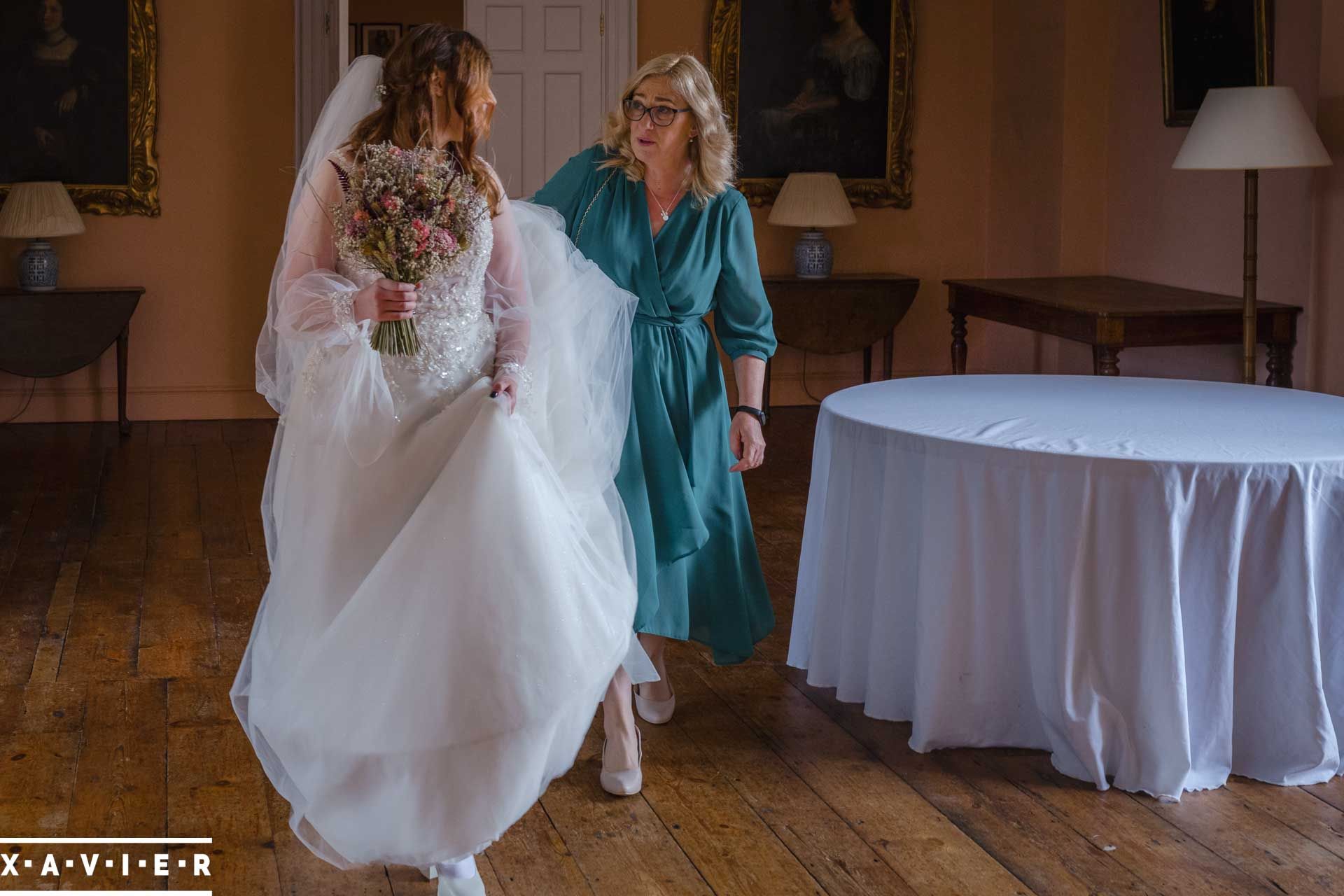 bride and mum walk to the ceremony