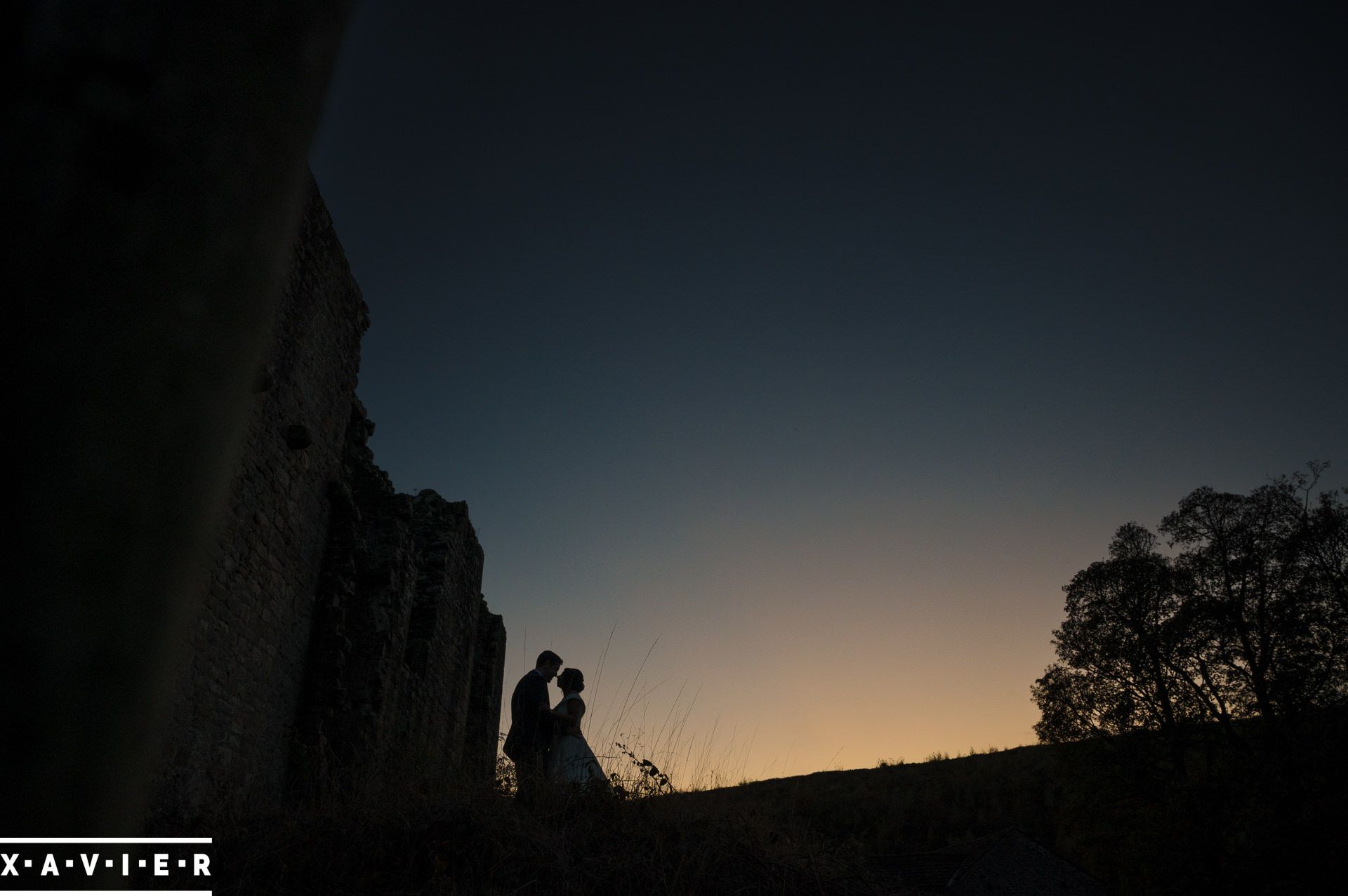 Silhouette of bride and groom with sunset behind