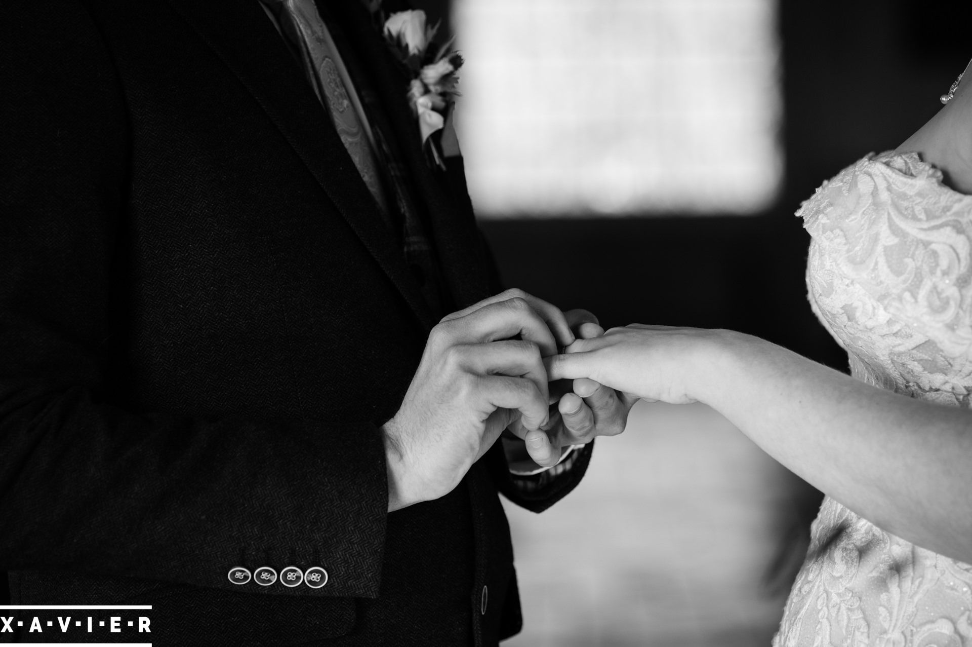 bride and groom exchanging rings