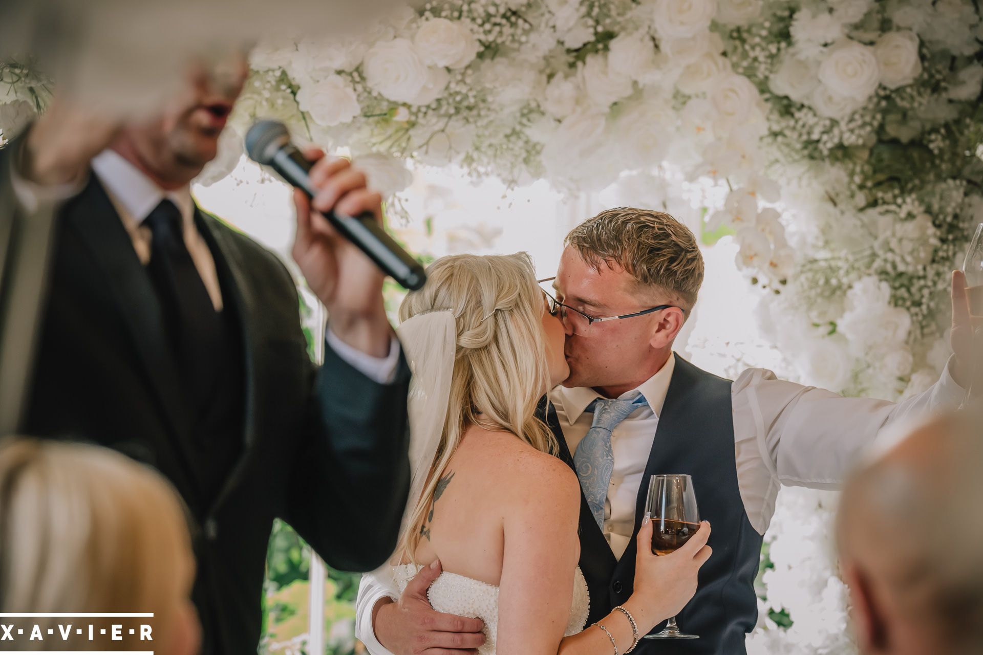 Bride and groom kiss during singing waiters performance