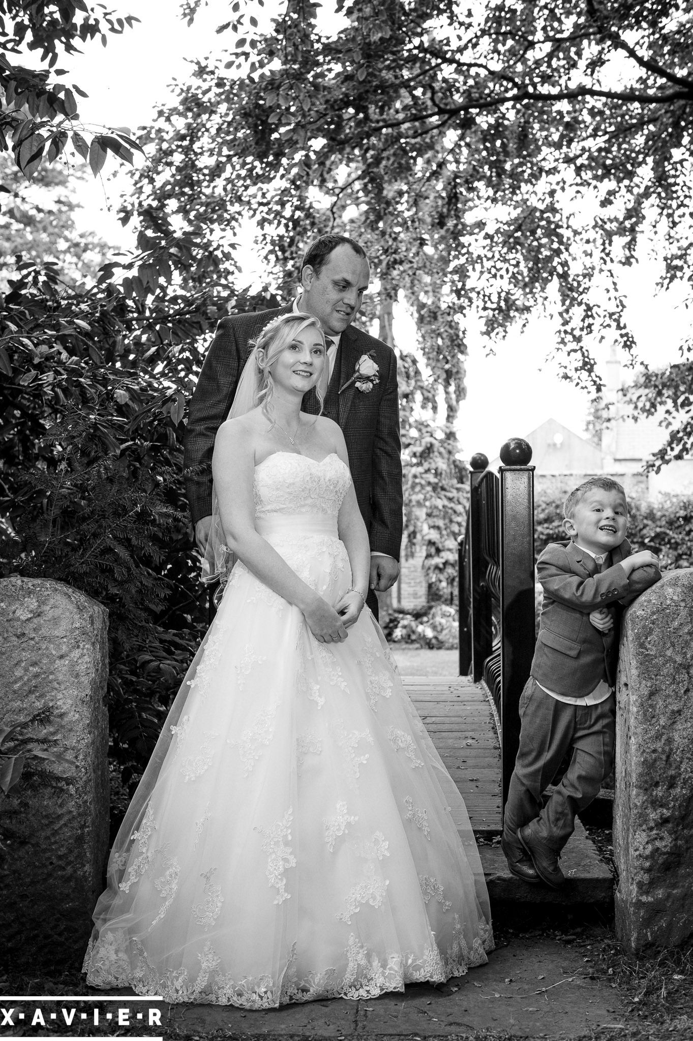 bride and groom pose with their young sons