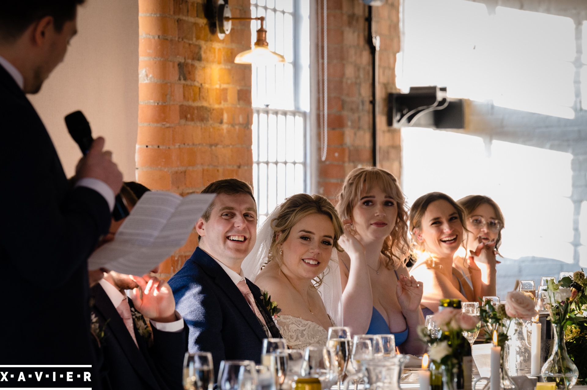 the top table laugh at the wedding speeches