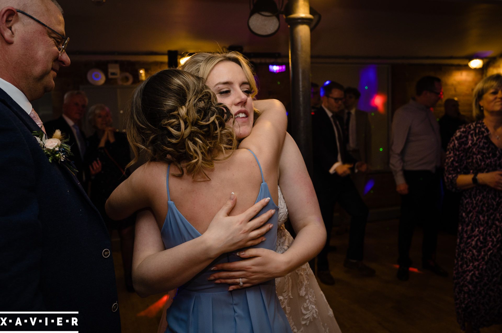 bride hugs her sister during the wedding dances