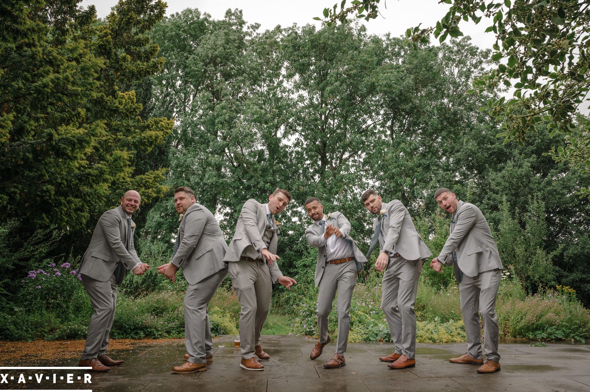 groomsmen line up to tee-off at the wedding venue