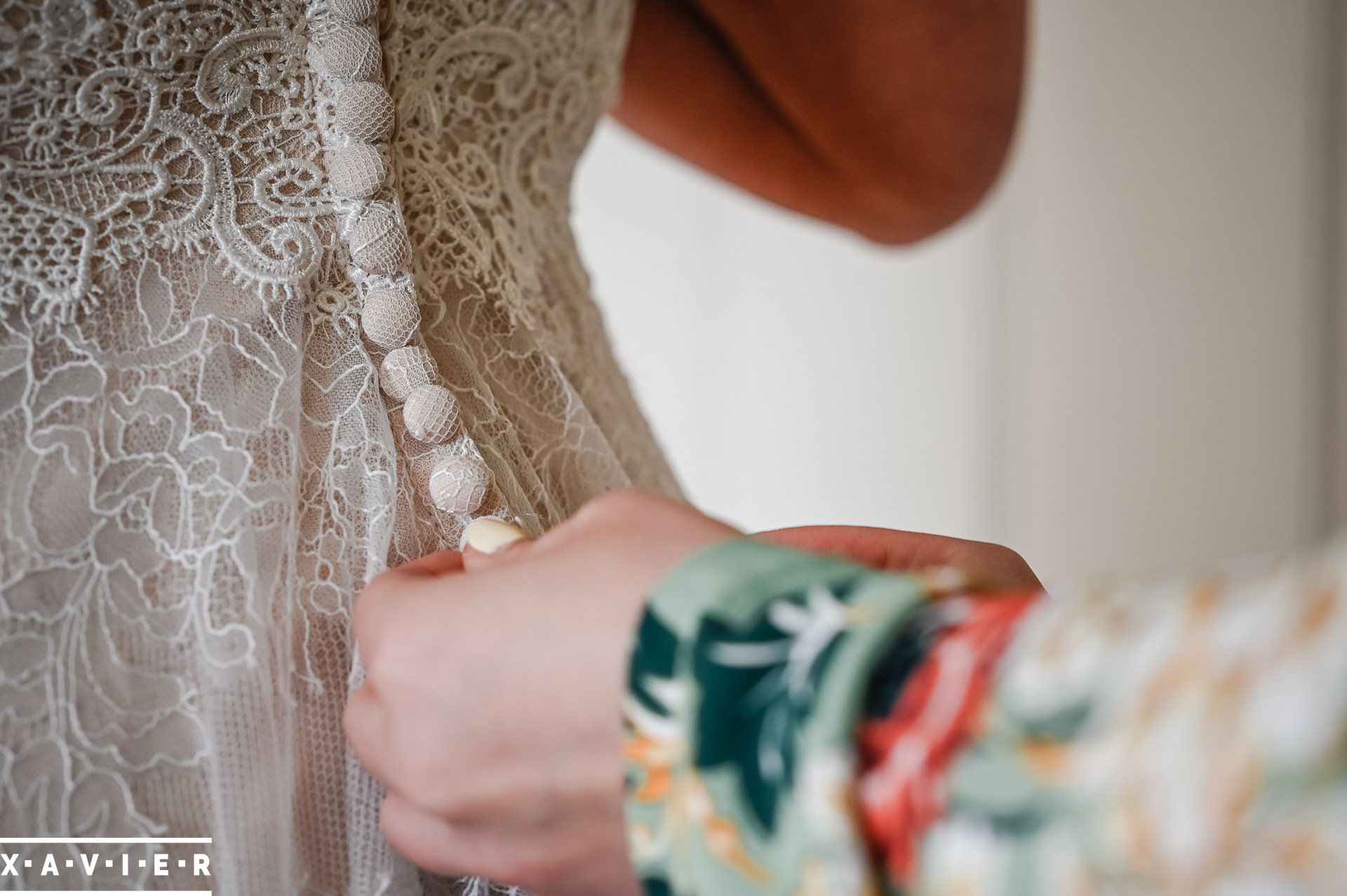 fastening the brides dress buttons