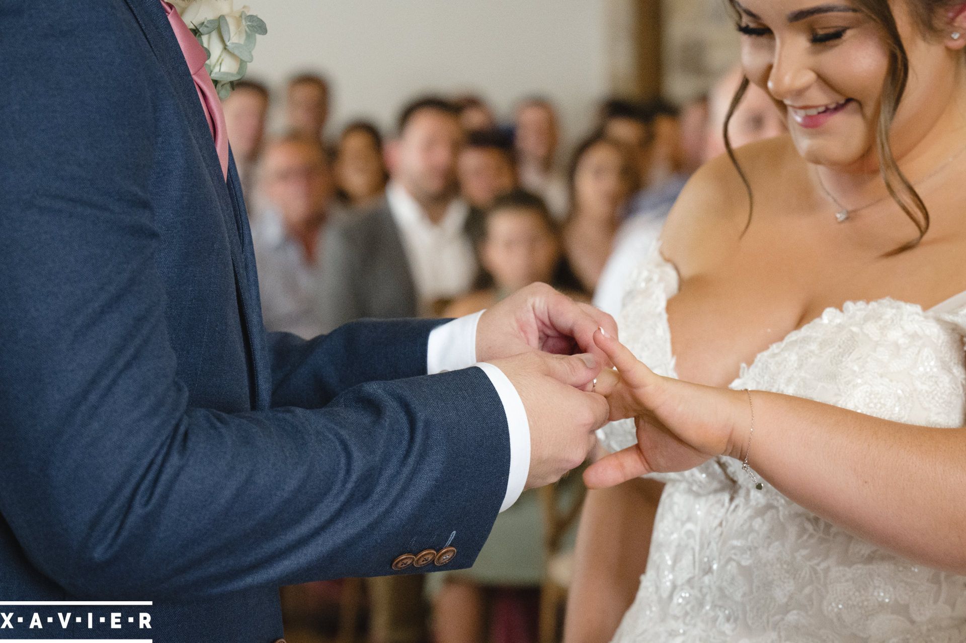 the groom puts the ring on the bride