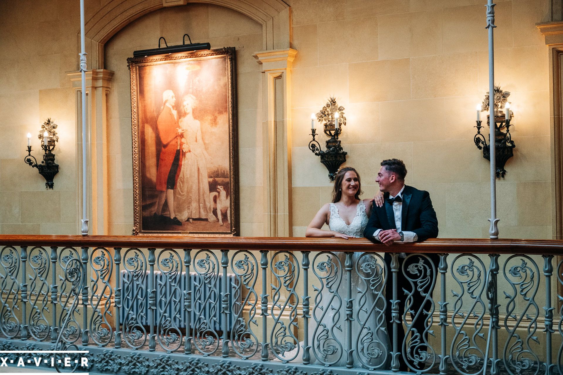 bride and groom stand on the balcony