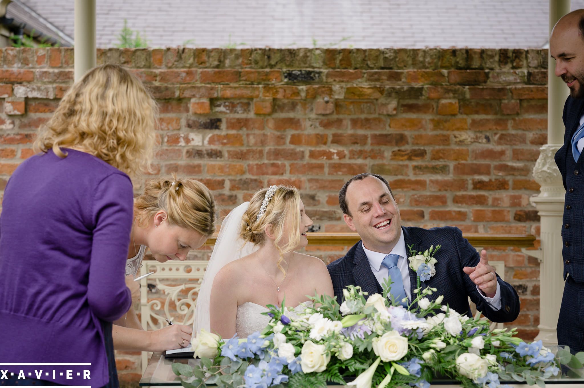 bride and groom laugh at the signing 