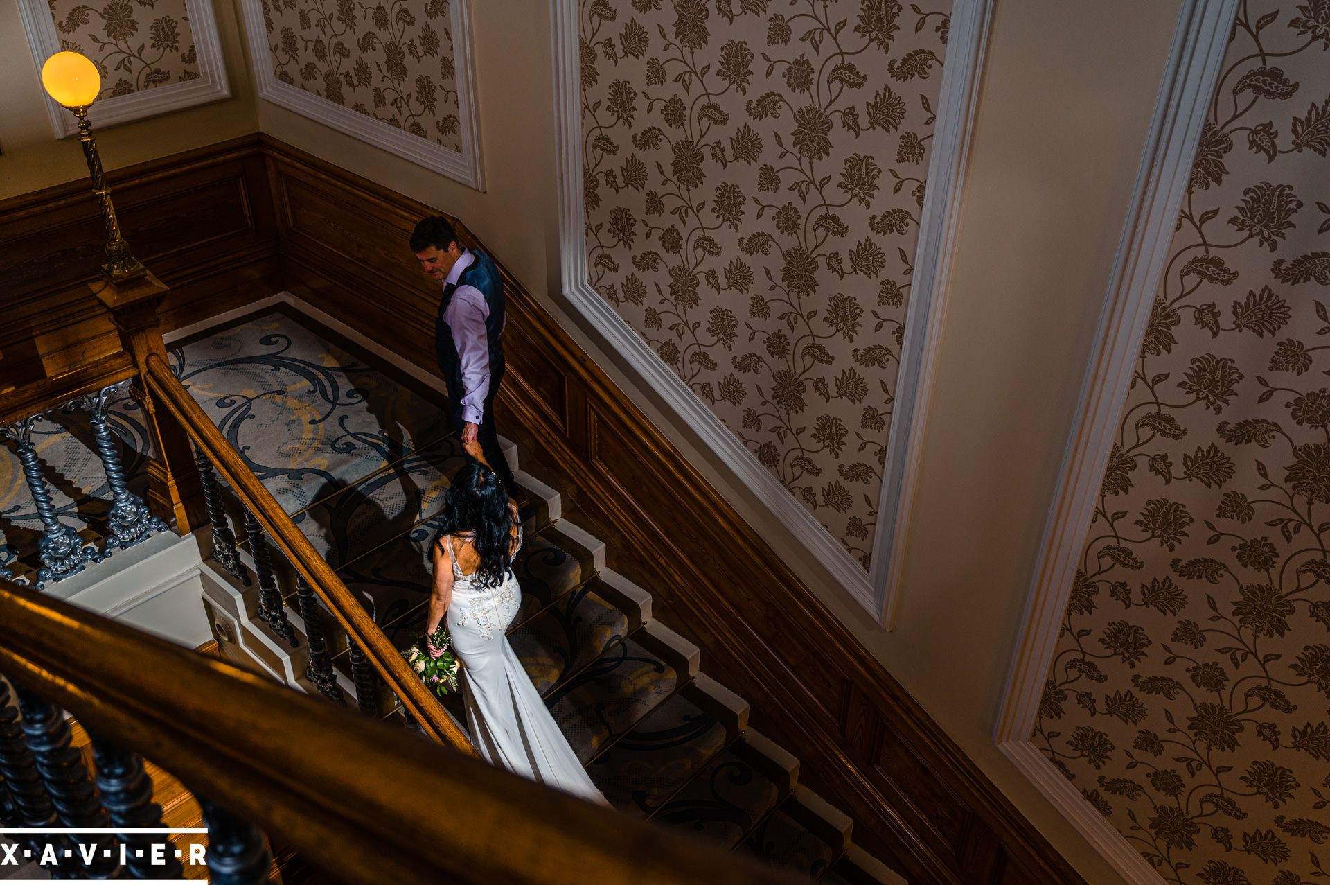 bride and groom walking up the stairs