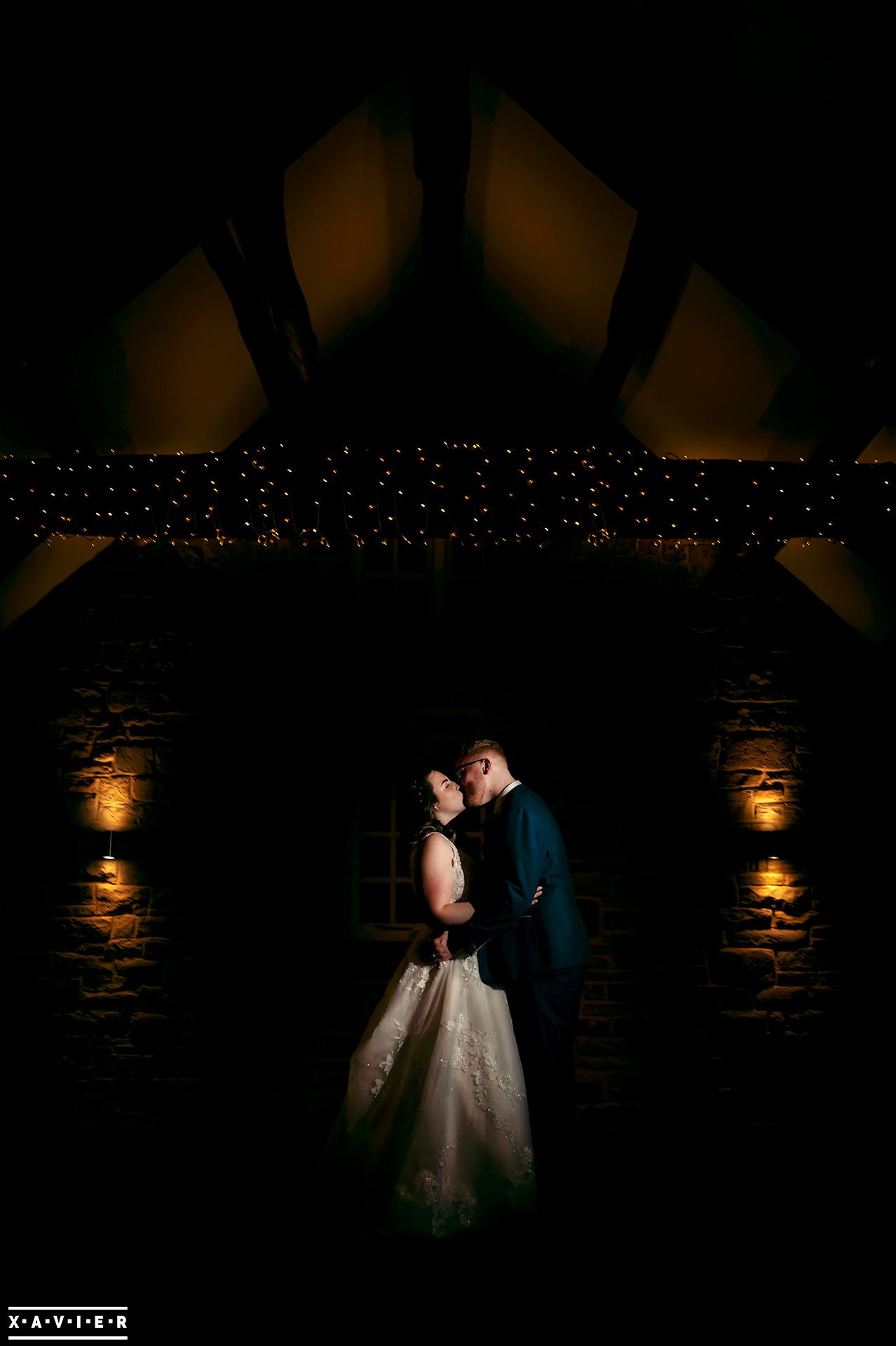 bbride and groom kiss in the barn