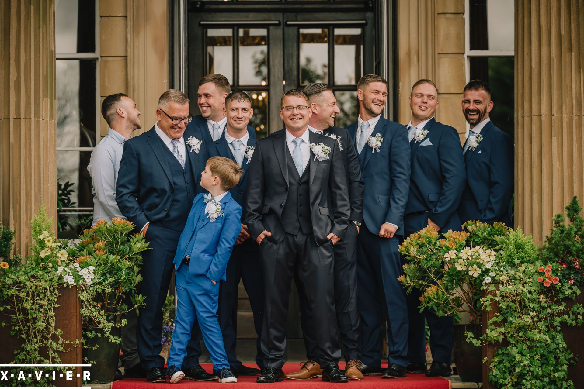 groomsmen standing at the front door of Oulton Hall