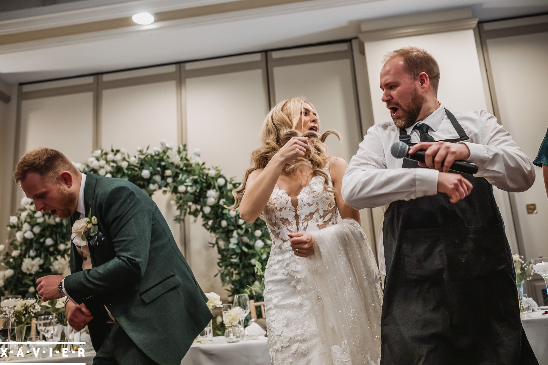 bride and groom dancing with singing waiter