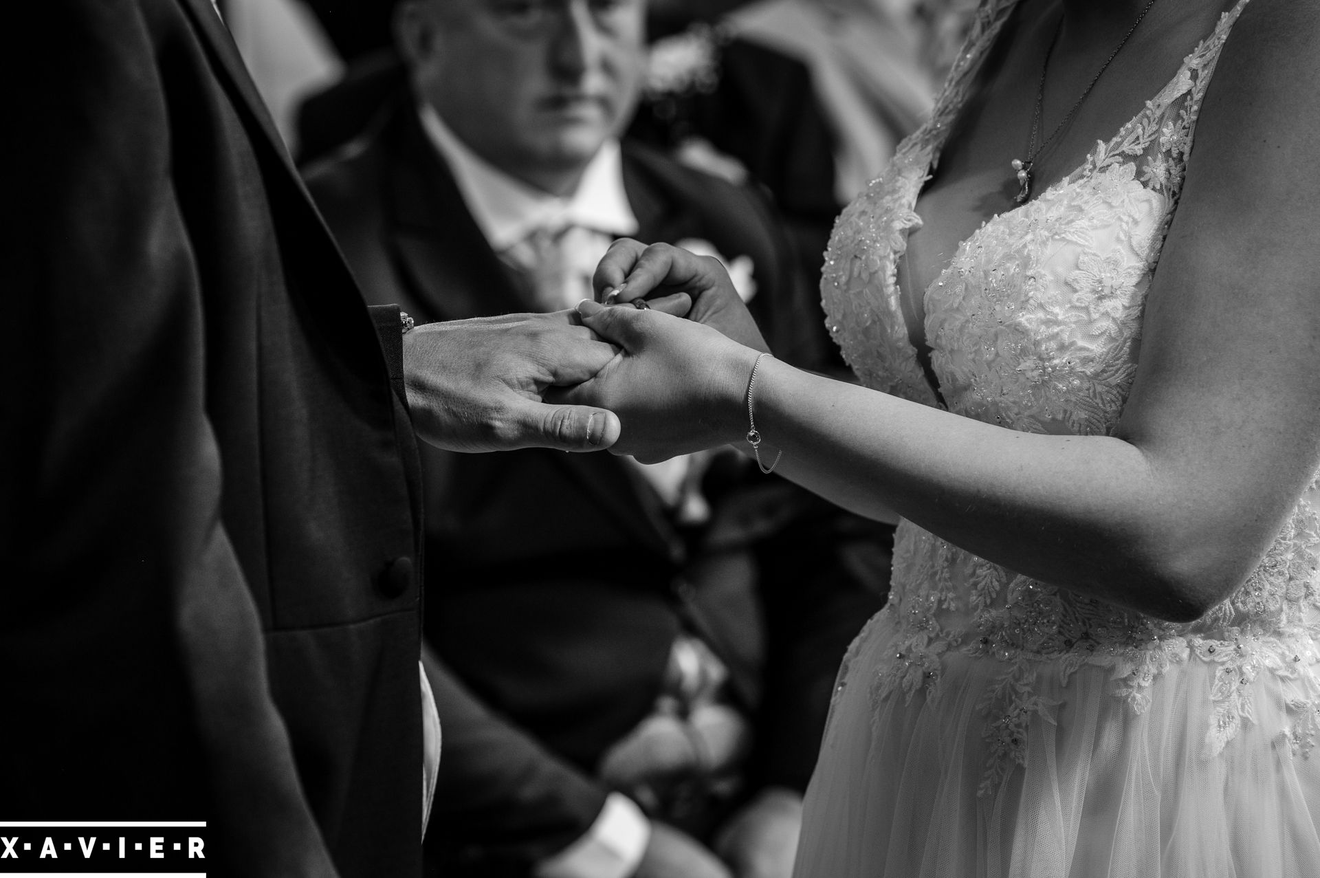 bride is placing ring on the grooms finger