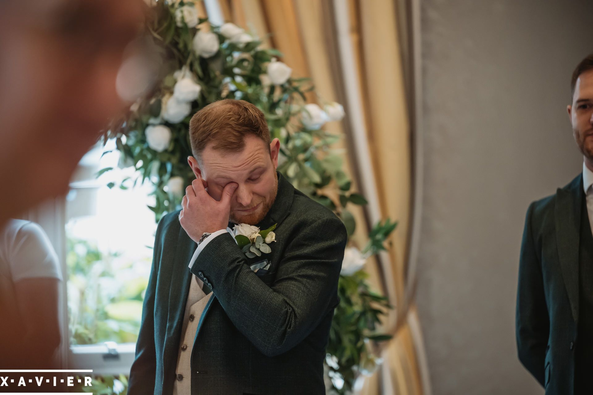 groom is emotional as he sees the bride