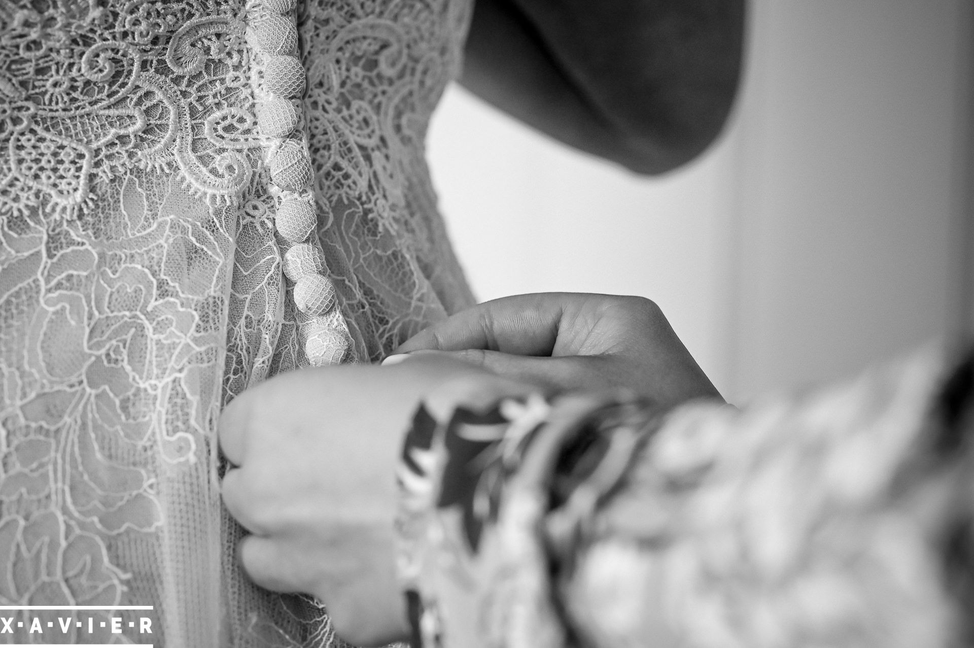 close up of fastening the brides dress