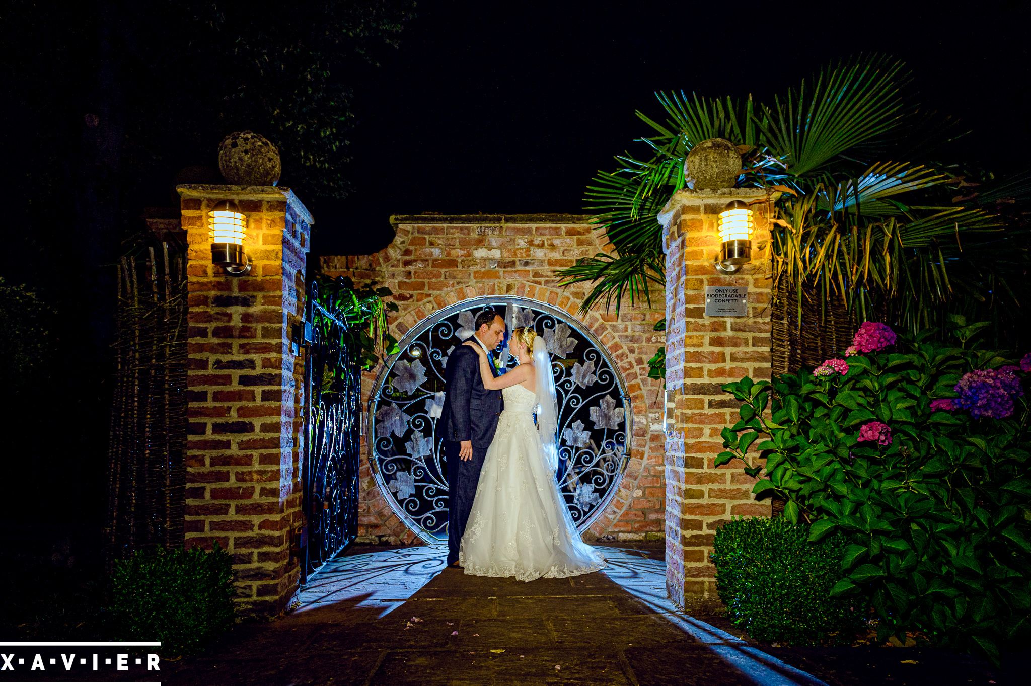 bride and groom stand outside the round gates