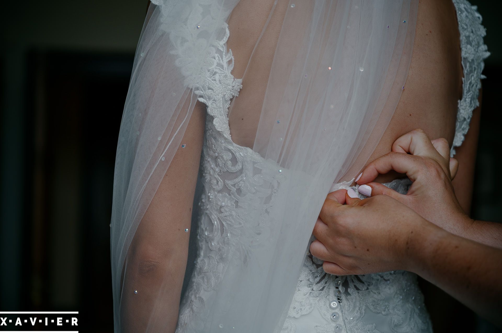 brides dress being fastened