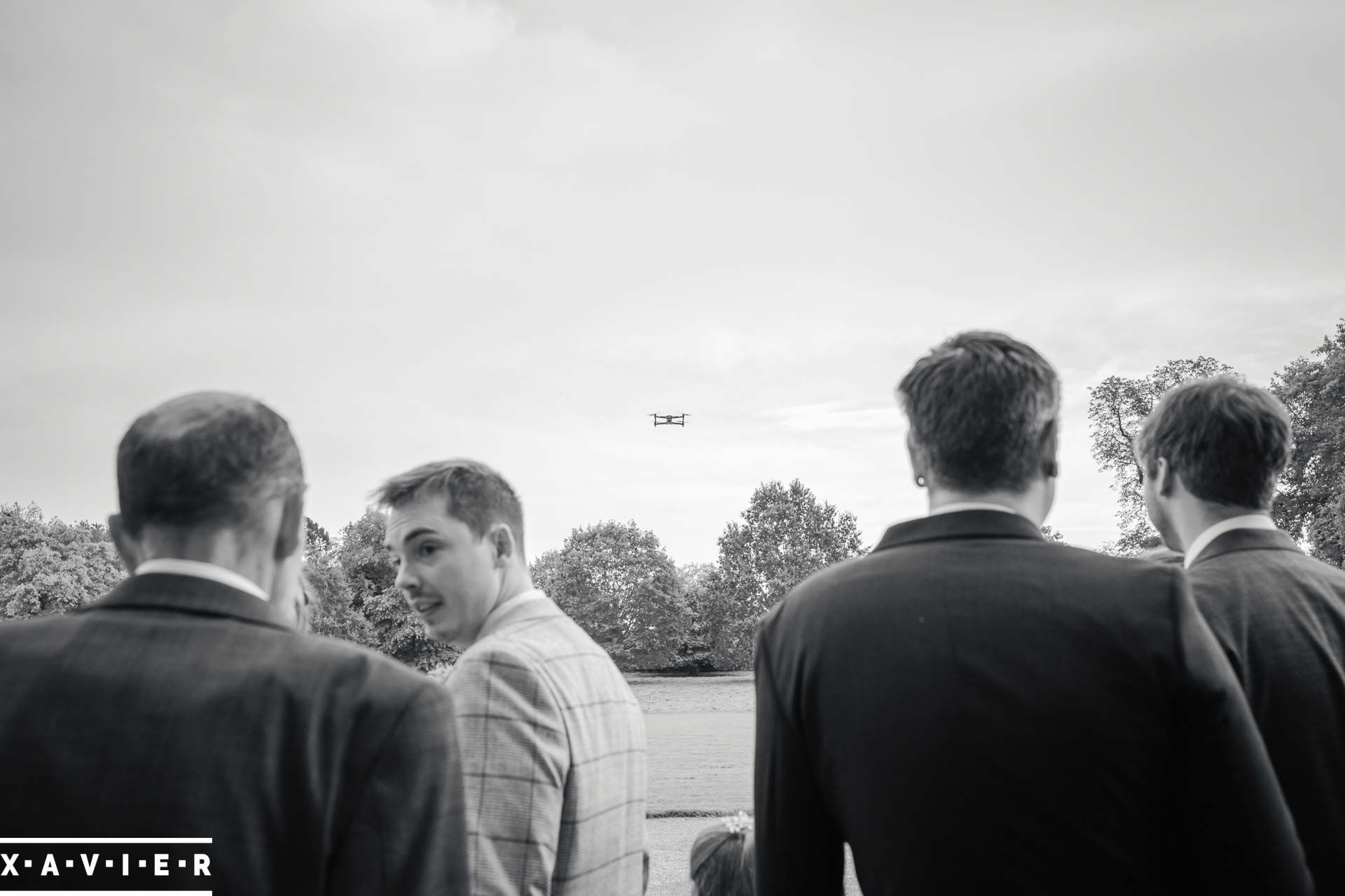 the drone flies in front of the wedding guests