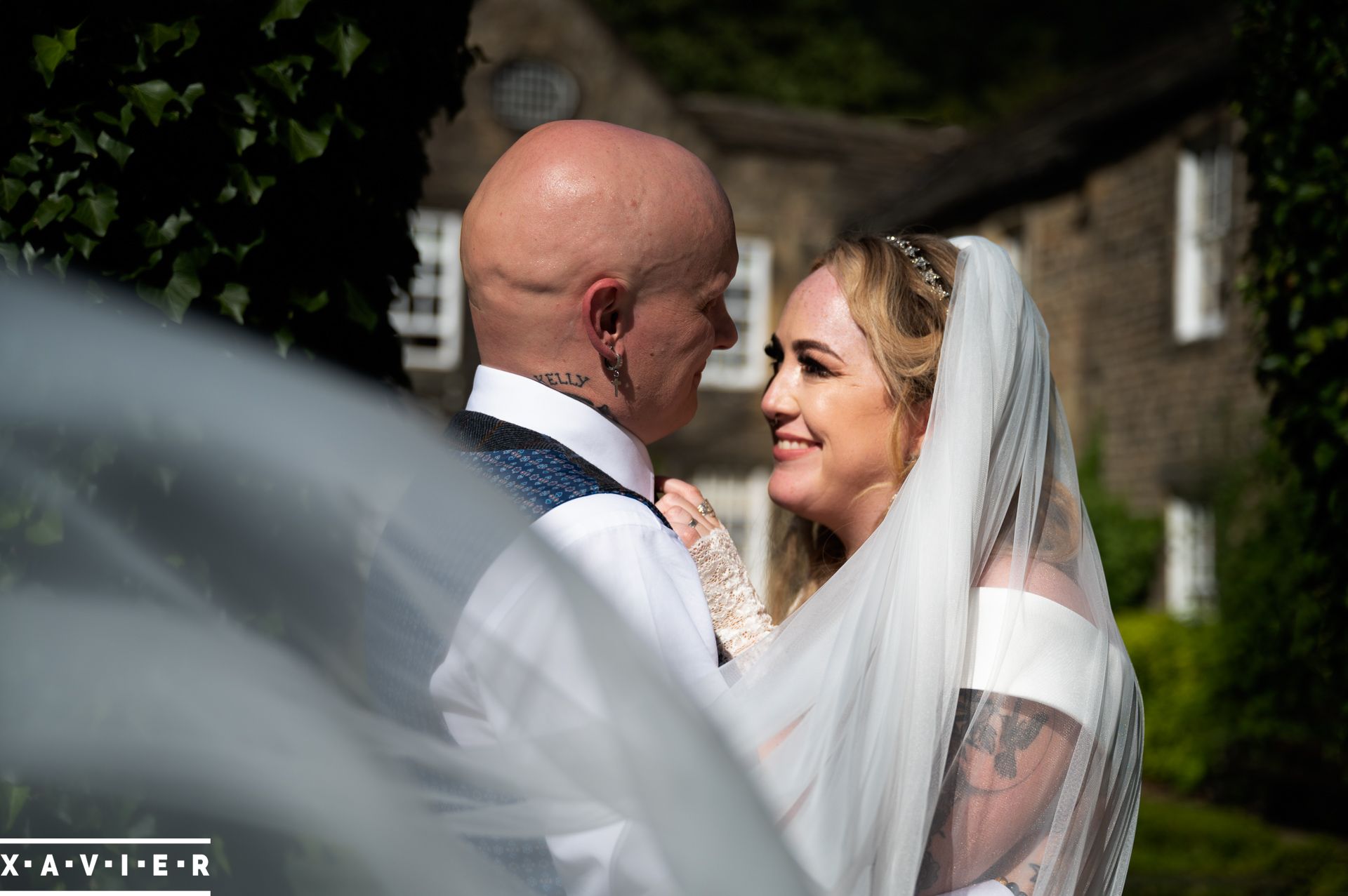 bride looks in love at her new husband in the hotel garden